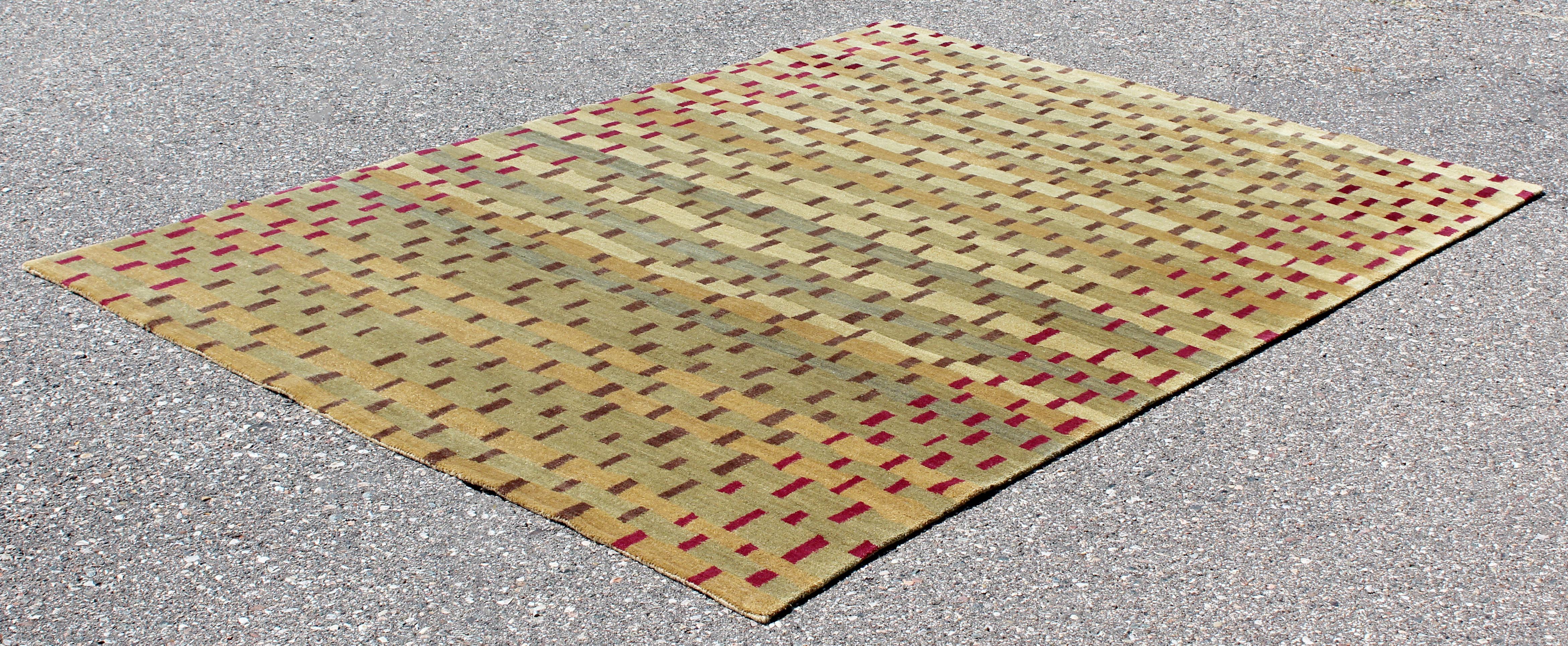 For your consideration is a wonderful, beige and red, rectangular area rug or carpet custom made by McQueens, wool & silk blend. In excellent condition. The dimensions are 85