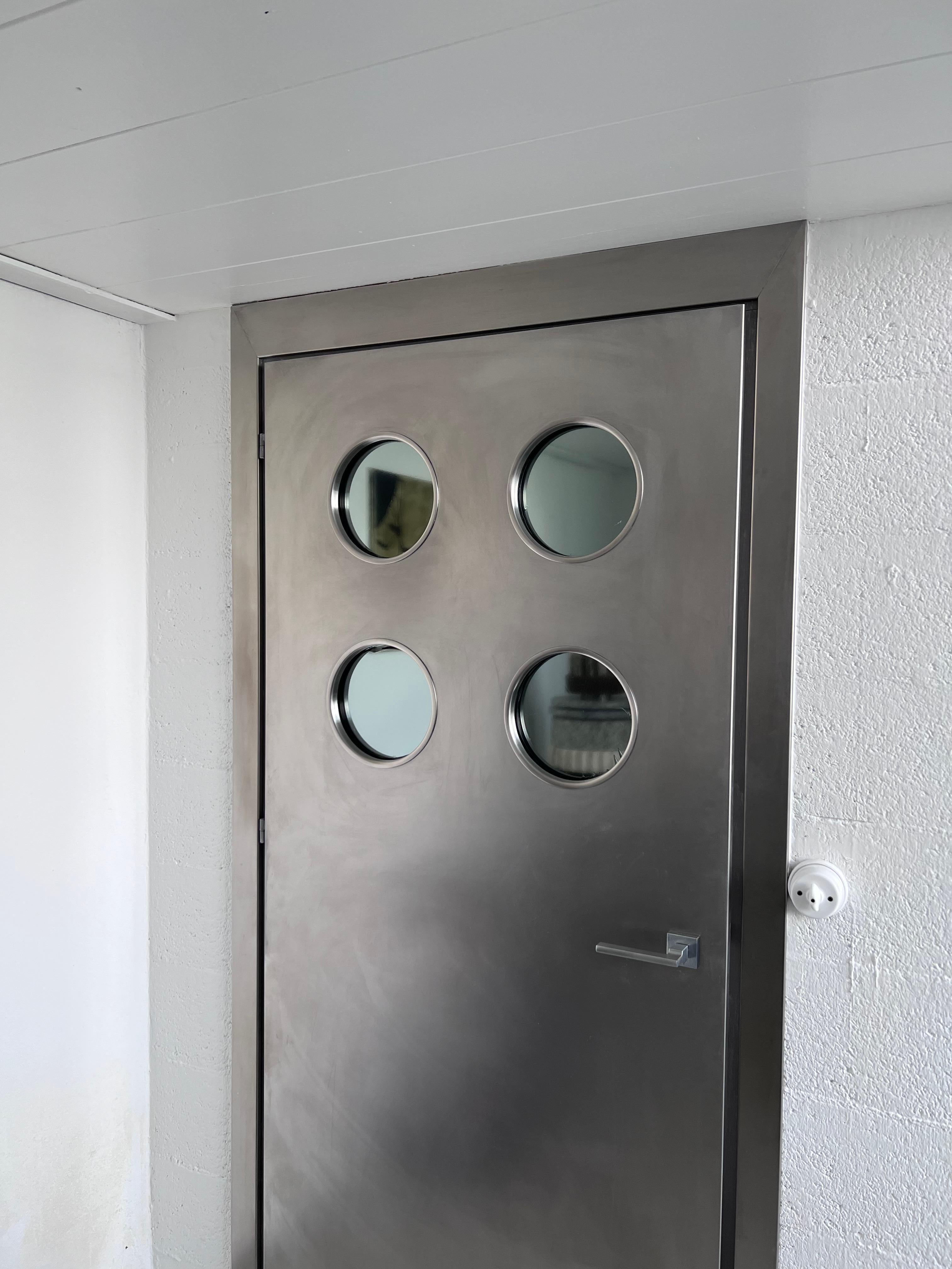 Italian Contemporary custom made Spinzi stainless steel metal door with round portholes For Sale