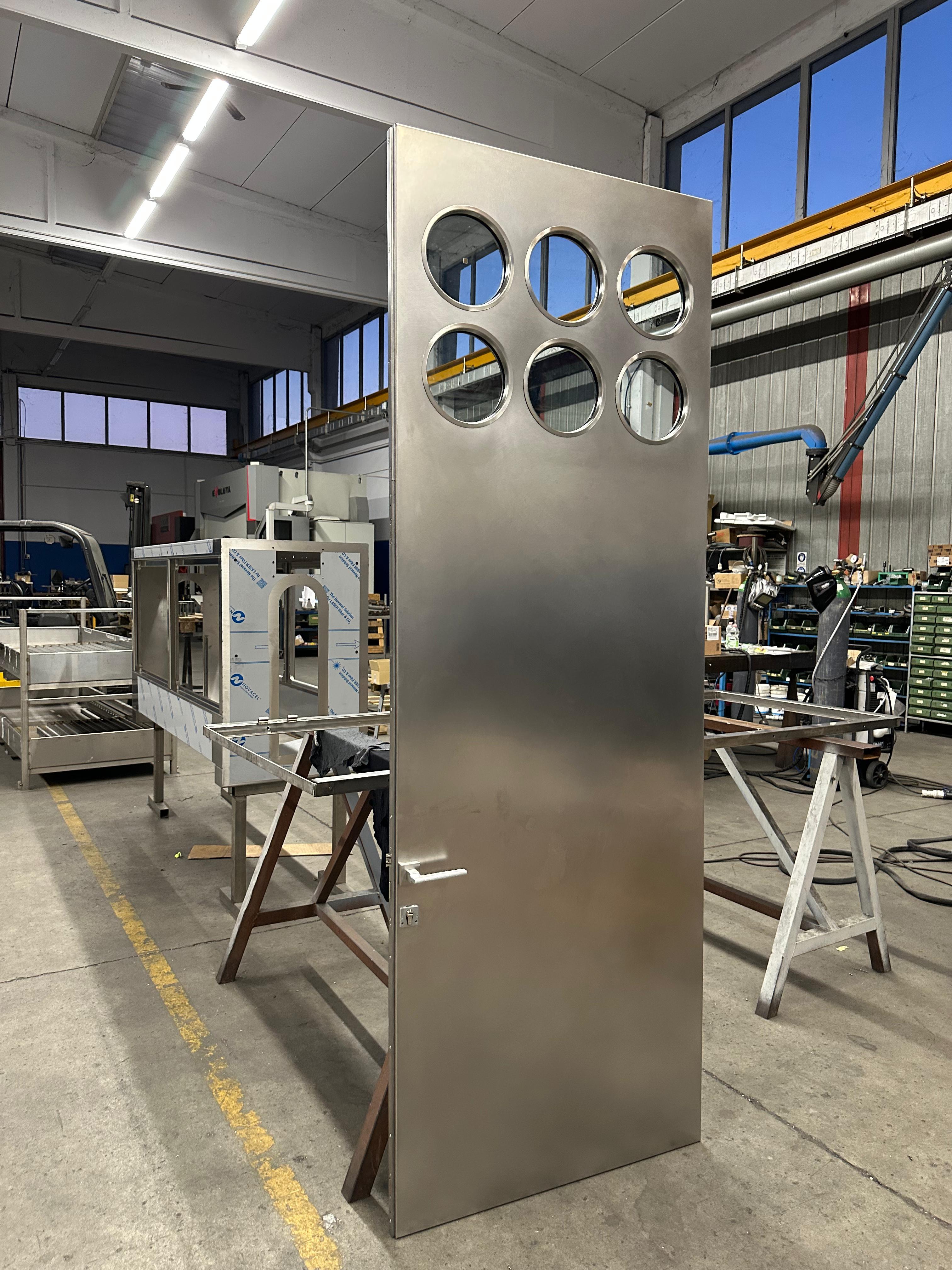 Italian Contemporary custom made Spinzi stainless steel metal door with round portholes For Sale