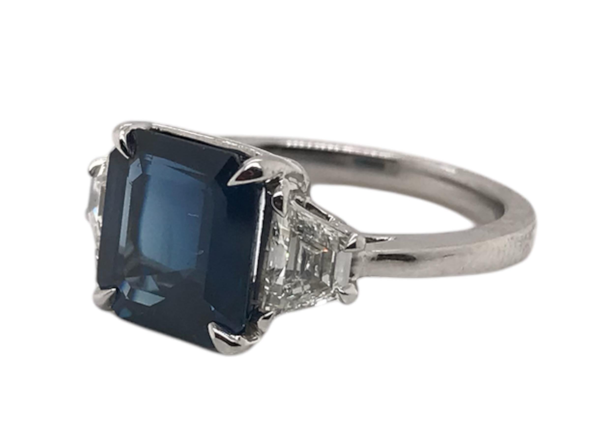 We love classic pieces such as this!
This lovely ring was custom made in platinum to showcase the beautiful combination of a midnight blue sapphire & vibrant white trapezoid cut diamonds.

Sapphire:
9.39mm X 8.72mm X 5.22mm Step Cut
Weight: 4.40