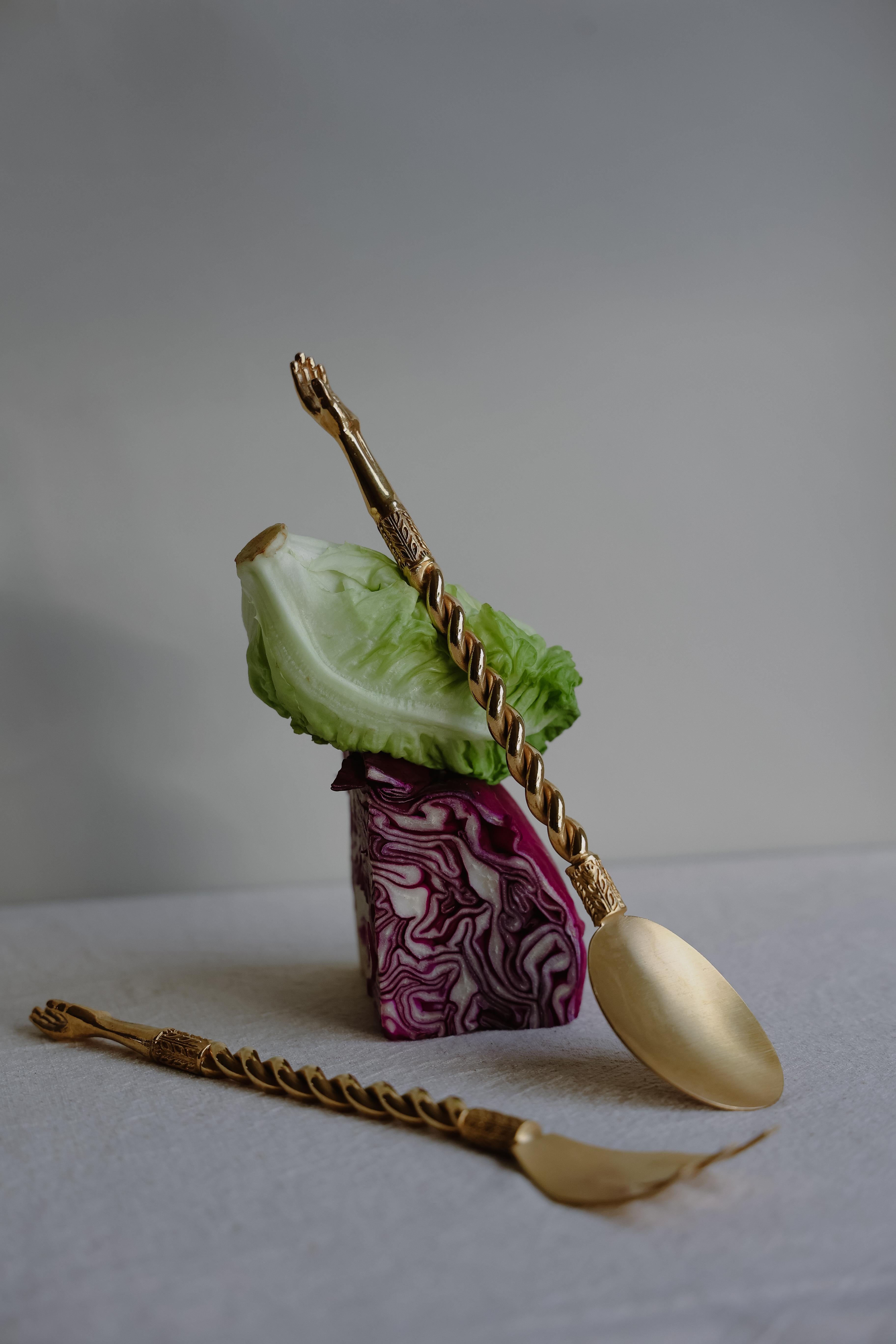 Add an element of elegance and playfulness to your dinner table with our hand servers. Handcrafted from metal and plated brass, its distinguishing feature is the anthropomorphic handle. A twisted stem seamlessly morphs into an intricately detailed