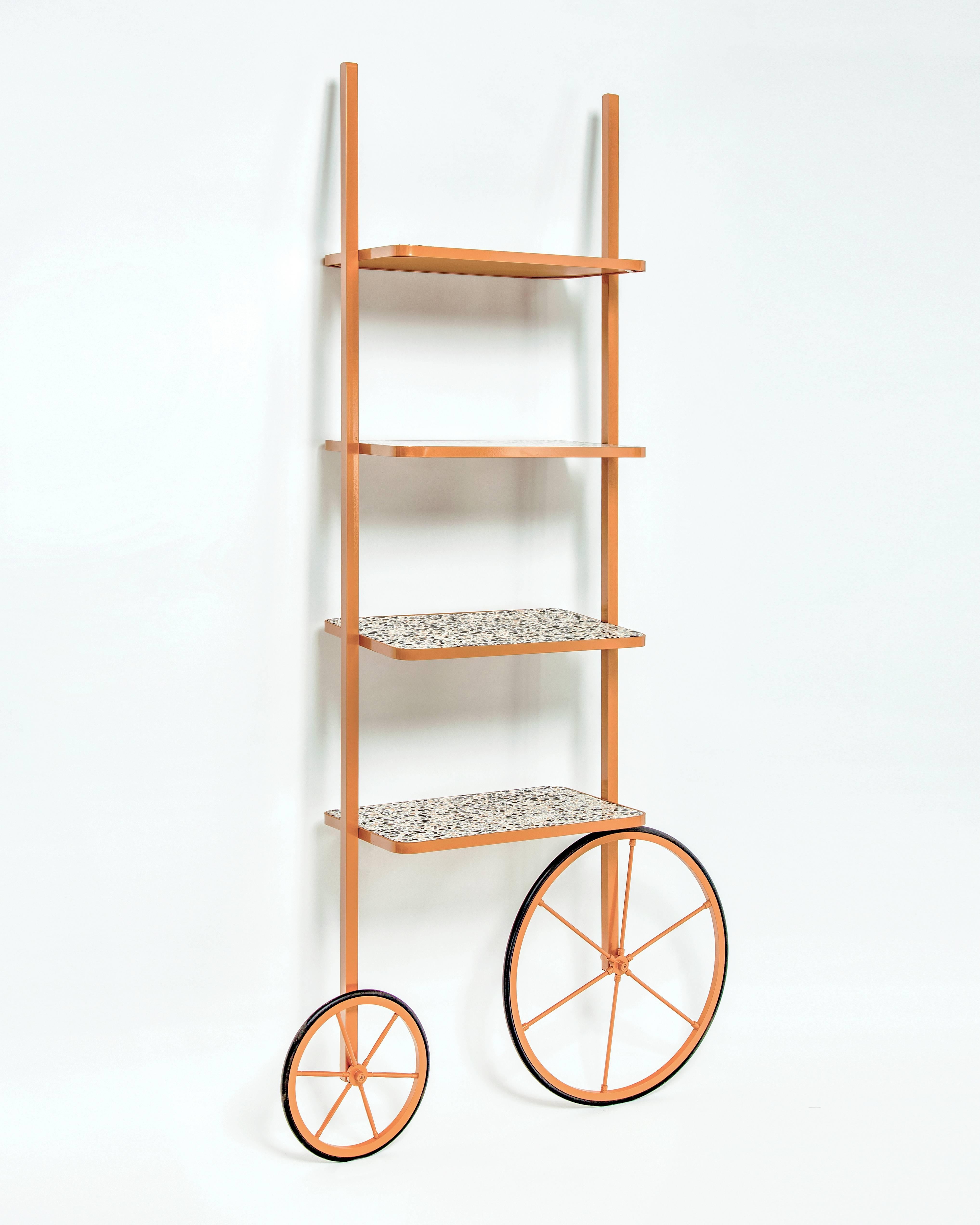 The design for Cyclopedia stems from the high wheel bicycles of the 1870s. Unlike most bookshelves, Cyclopedia differentiates itself through its portable structure. This unique piece is a library and a display shelf that can be wheeled and