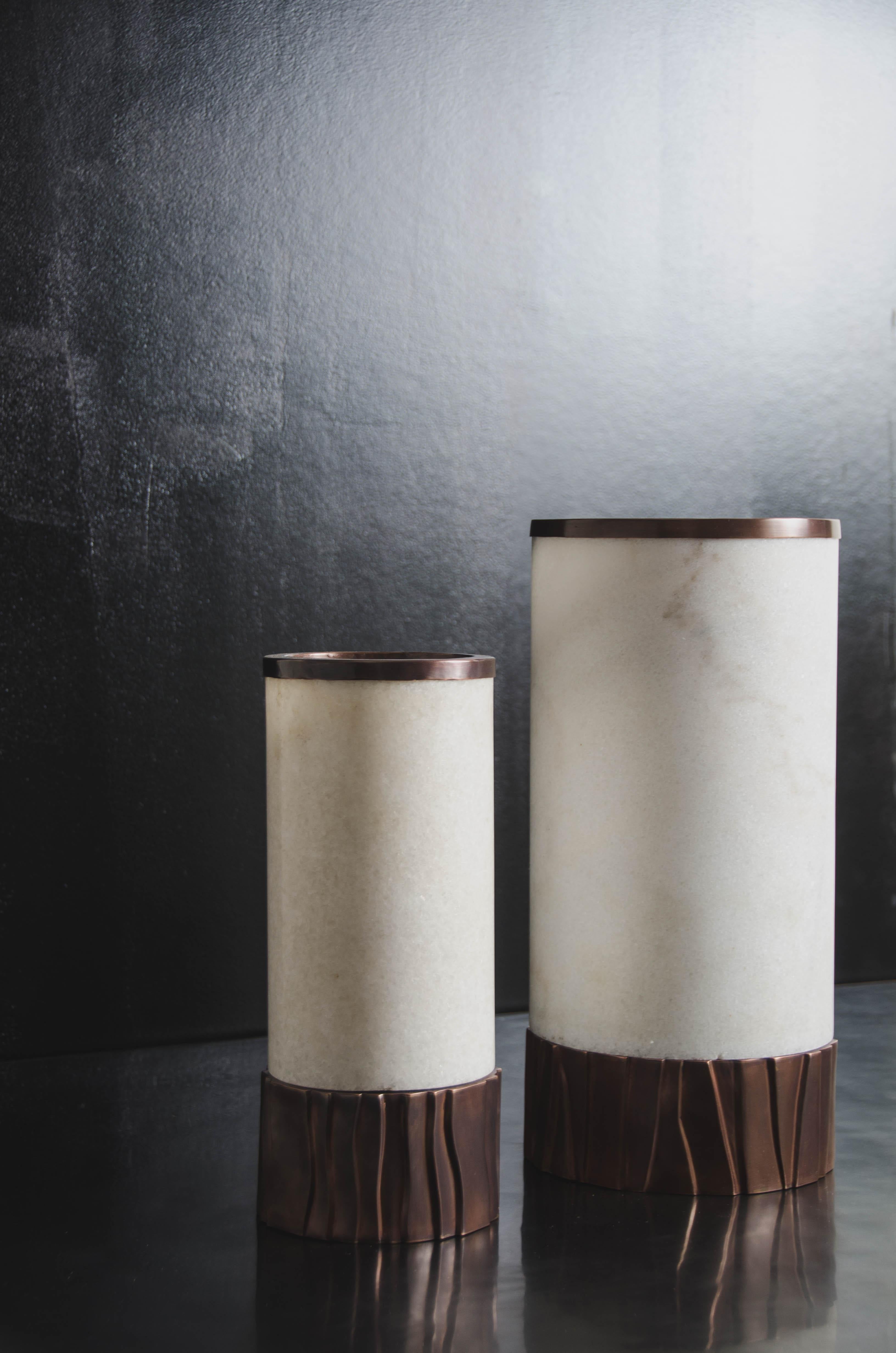 Cylindrical Alabaster copper trim lamp w/ Kuai base
Alabaster
Copper
Hand Repoussé
Limited Edition
Each piece is individually crafted and is unique

Repoussé is the traditional art of hand-hammering decorative relief onto sheet metal. The