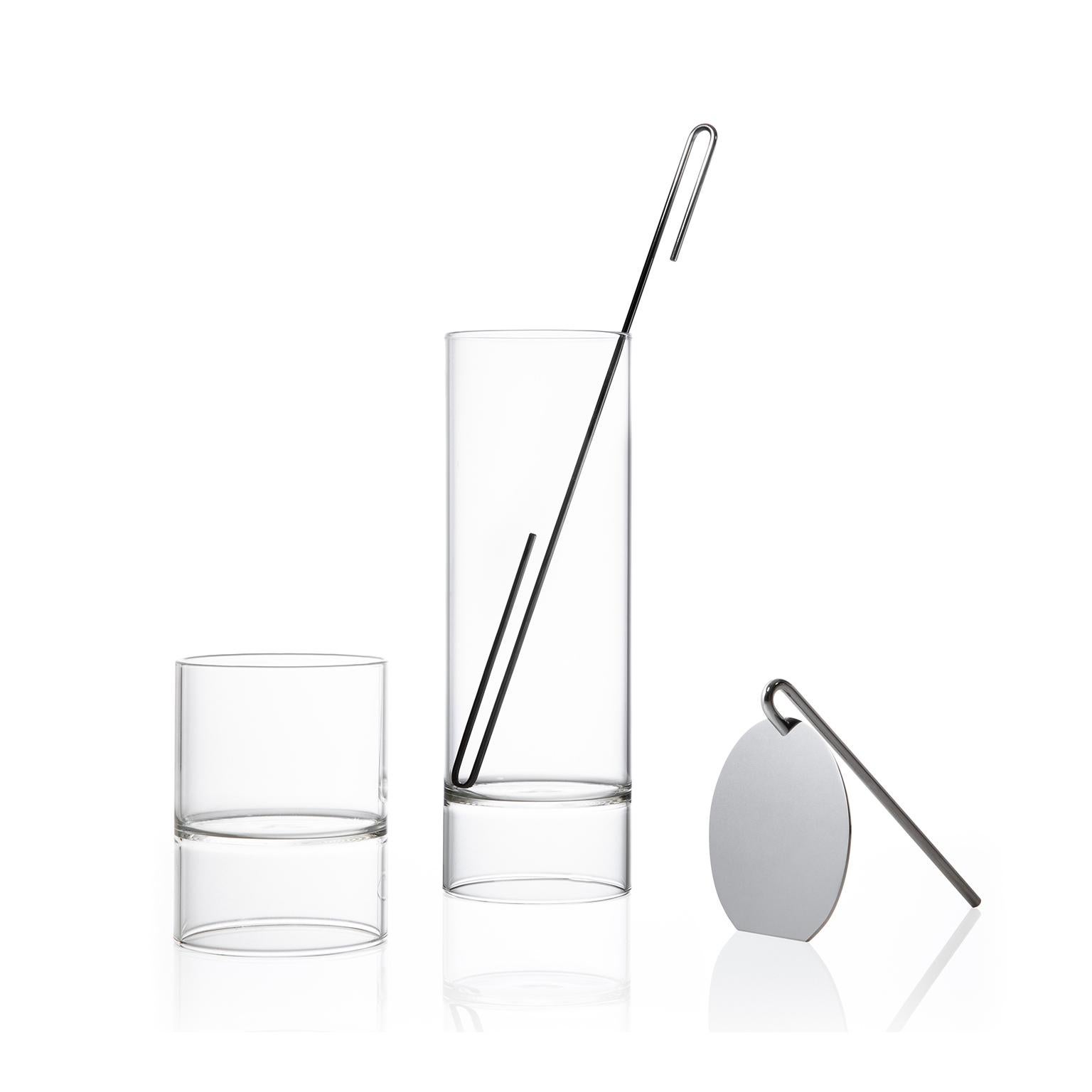 The contemporary Czech glass minimal Revolution collection set includes a cocktail mixer carafe, strainer, stir stick, and four double-ended rocks martini glasses. 

Strikingly simple in form, the minimal Revolution collection is handcrafted in