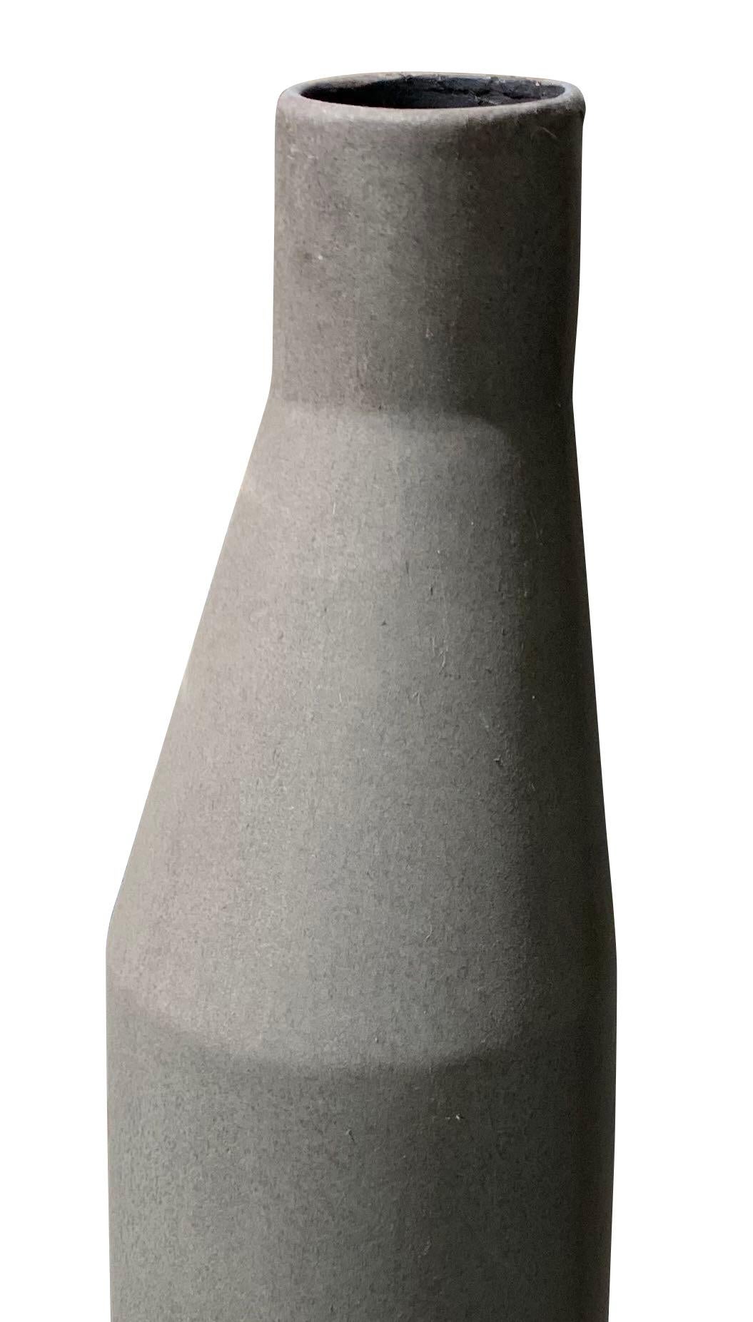Contemporary Danish design tall vase with curved top
Matte grey glaze
One of a collection of many shapes and sizes.