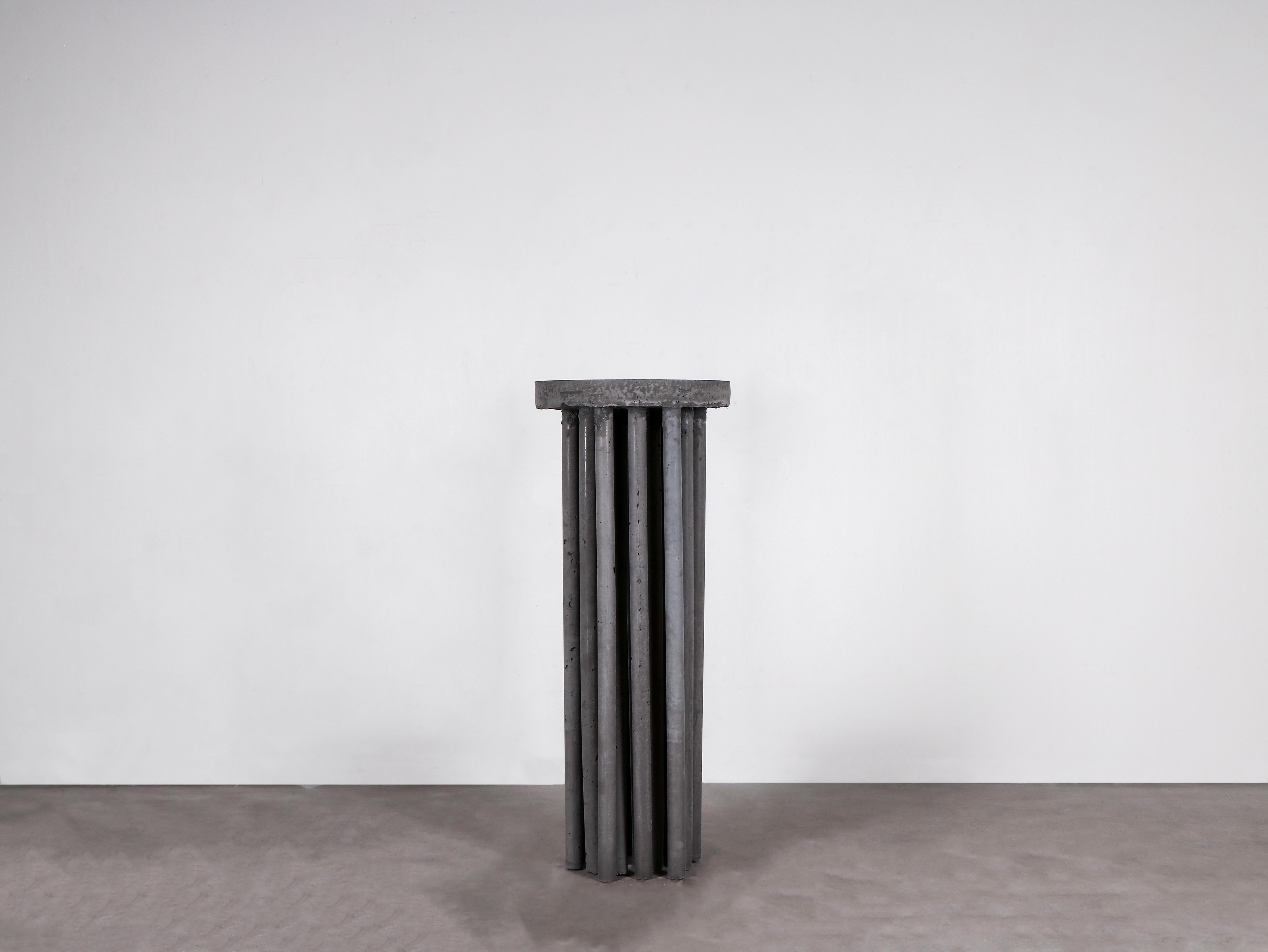 Contemporary dark grey pedestal in Concrete - Dop Plinth by Lucas Morten

2022
Limited edition of 6 + 1 AP
Dimensions (cm): Diameter 30 height 100
Material: sculpted in colored concrete

With elements fetched by the architectural era
