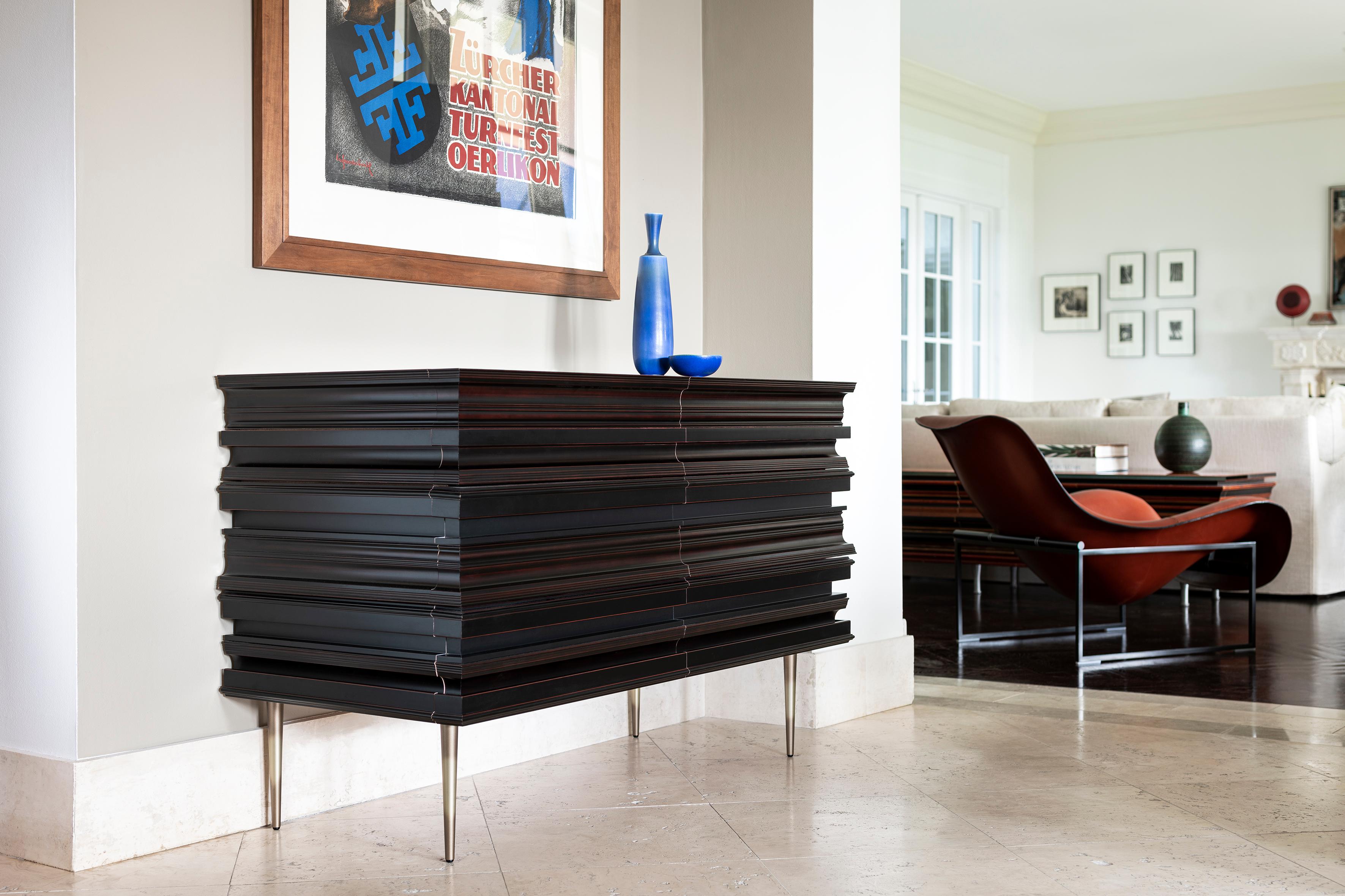 Finest crafted darkened wood moldings and lacquer credenza. Moldings are applied to conceal drawers and acting as handles for the piece. The process to achieve the credenza ’s surface is the result of the combination of multiple moldings with
