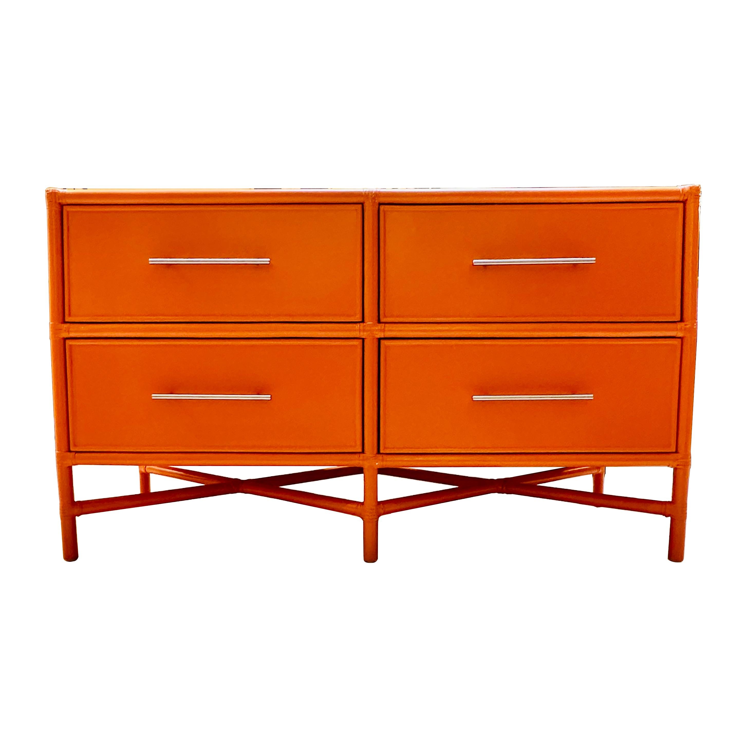 Contemporary four-drawer orange “Venice” dresser by American furniture maker David Franics Furniture. Hand painted rattan and wood frame with accents of rawhide bindings. Versatile and highly functional this dresser is a perfect blend of natural
