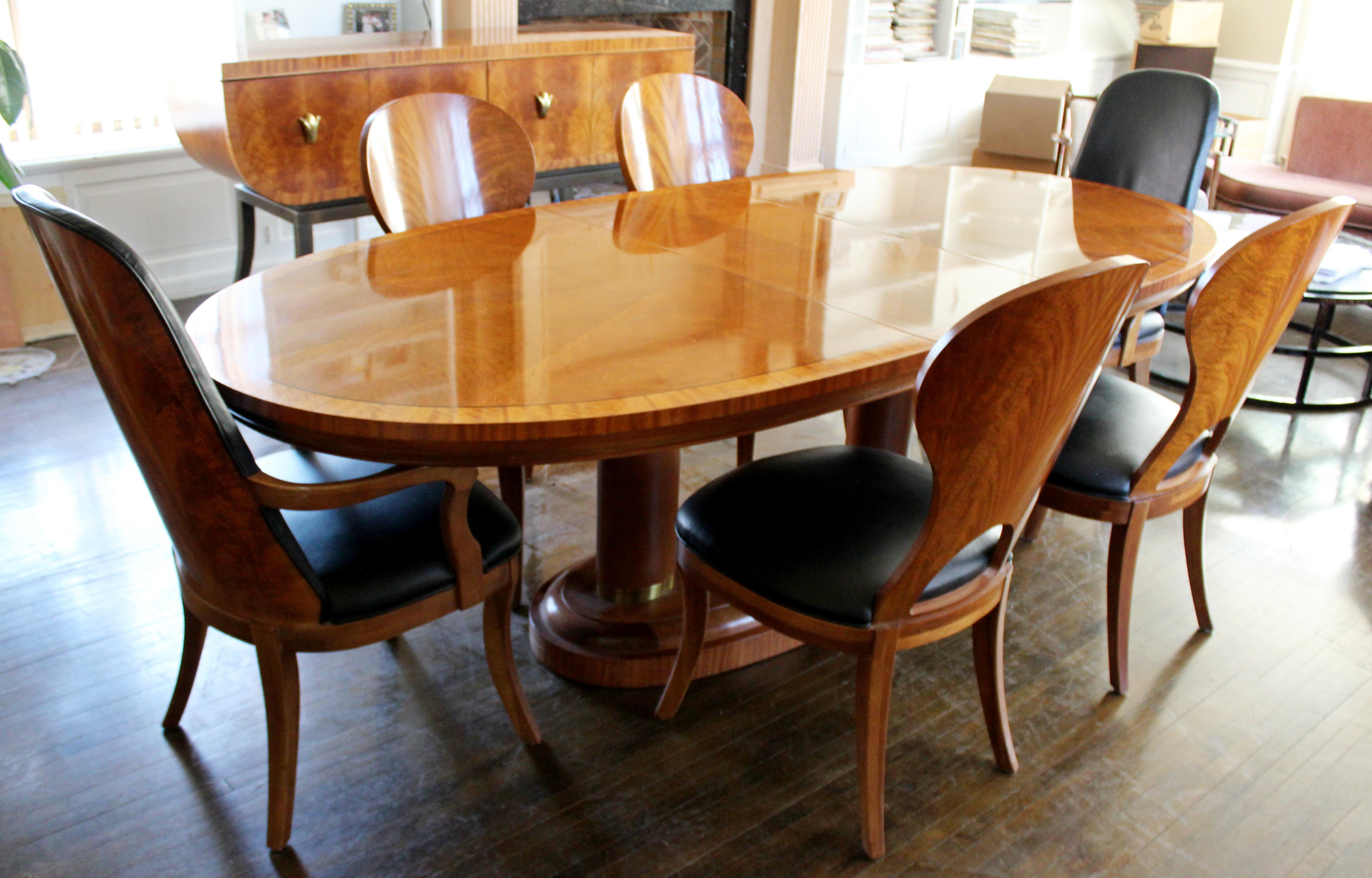 For your consideration is a truly sensational dining room set, including an expandable burl wood table and six chairs, two arm and four armless, and matching credenza, in the Art Deco style, by Henredon, circa the 1990s. In excellent vintage