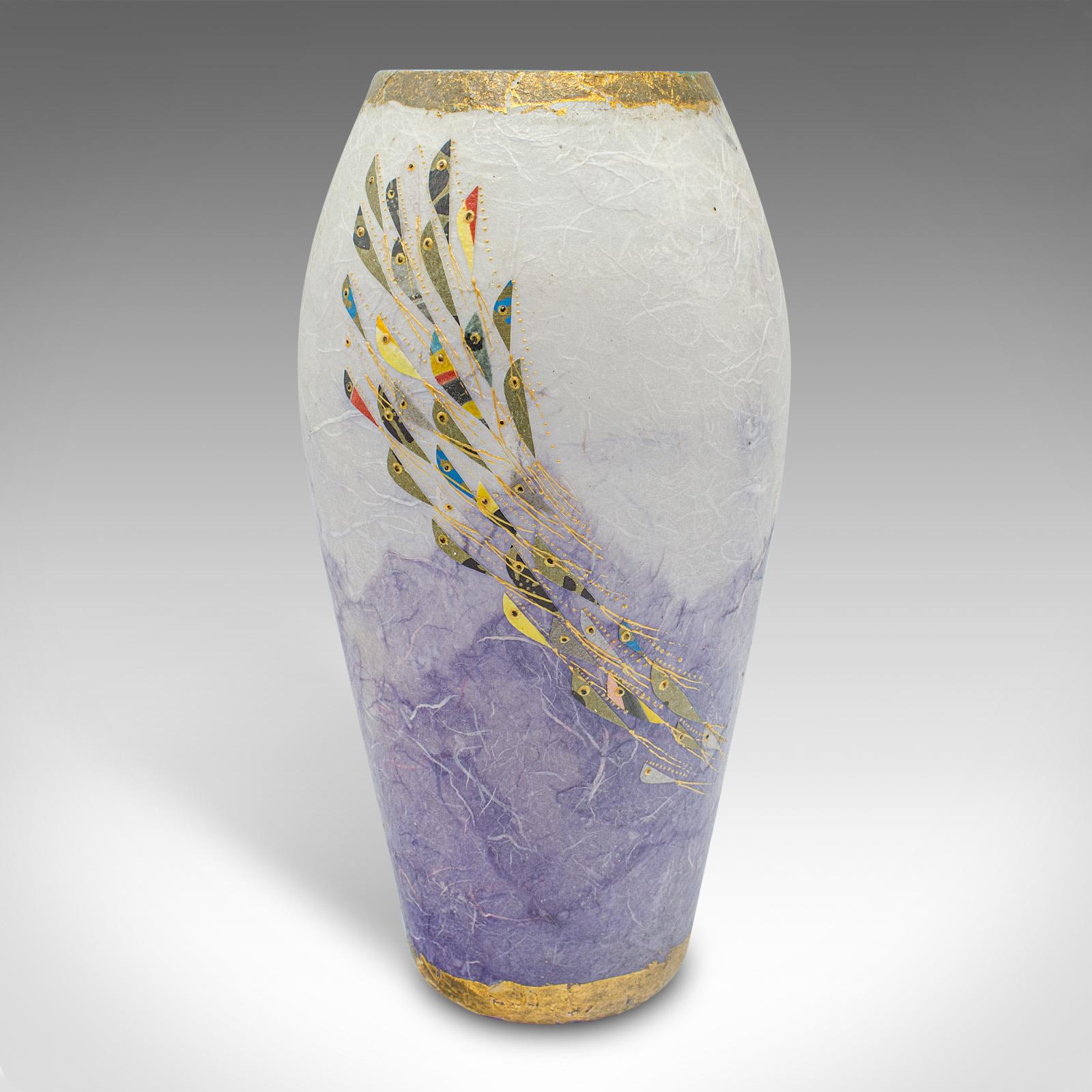 
This is a contemporary decorative flower vase. An English, art glass sleeve with straw silk finish, by Margaret Johnson.

Beautiful colour with fish motif attracts the eye
Displays a desirable, contemporary appearance
Tastefully coloured glass with