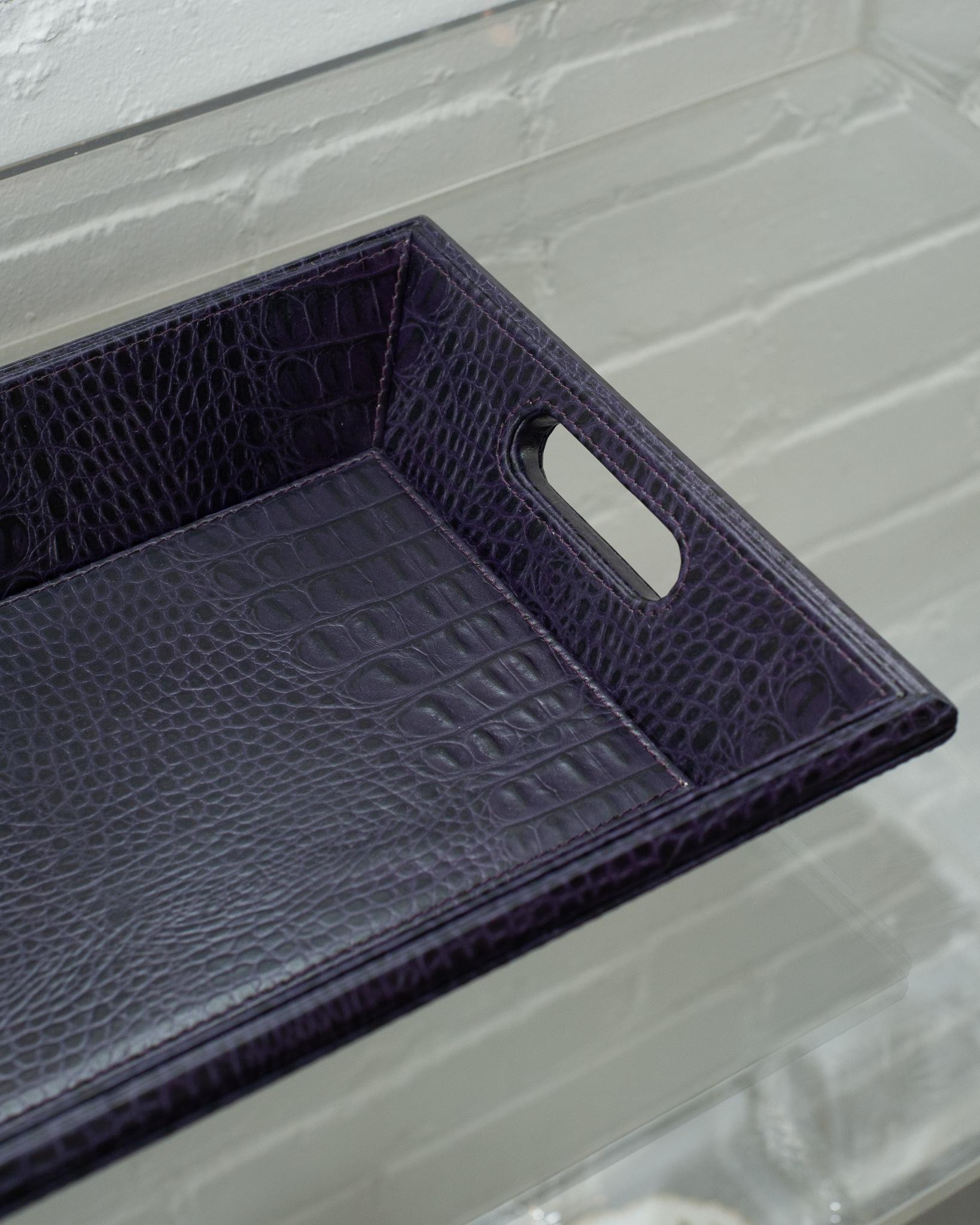 A beautiful deep purple crocodile embossed leather tray, perfect for the desk, bedside table, or use as a serving piece. Fully wrapped in embossed leather with stitched panels, each tray has two openings for carrying.