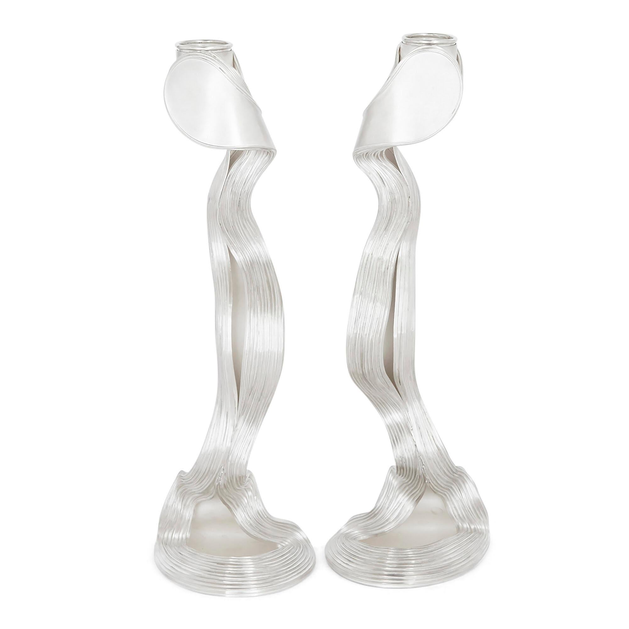 These candlesticks, that resemble free-flowing ribbons, were handmade by award-winning contemporary silversmith Nan Nan Liu. 
Fully hallmarked to London 2020 and signed with the artist's initials. 
English, 2020
Measures: Height 25cm, width 7cm,