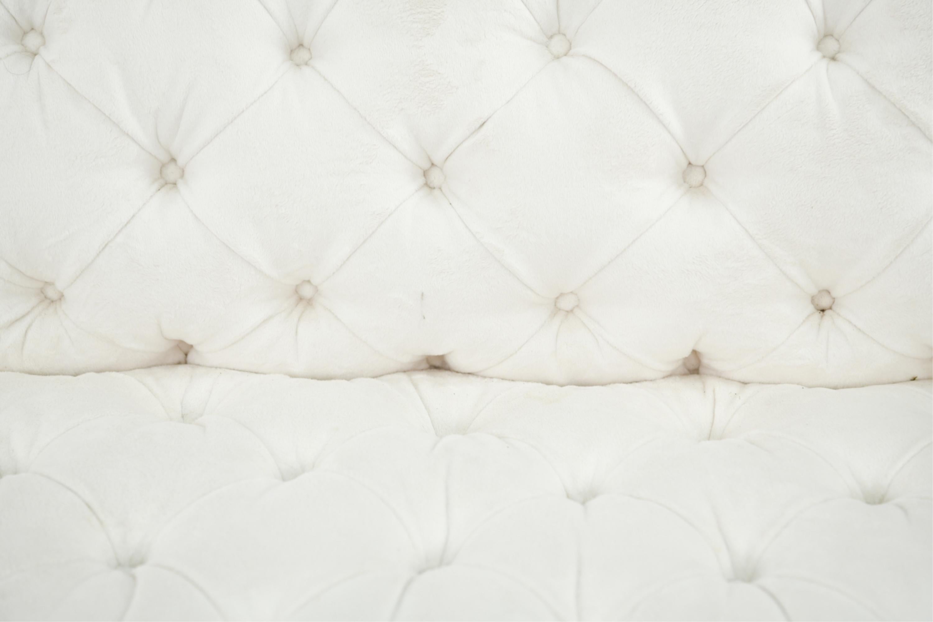 Custom made sofa, upholstered in an off-white faux fur, extra soft and sleek fabric.