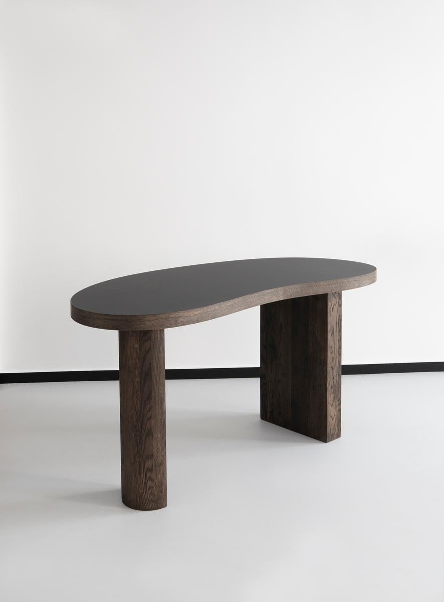 Desk table MS Bean
Designed by IDA L. HILDEBRAND

Dimensions : L. 150 cm / D. 70 cm / H. 75 cm
Top thickness : 5 cm
Model shown in the picture : Smoked oak - Black tabletop laminated

Contemporary design studio Friends & Founders was founded