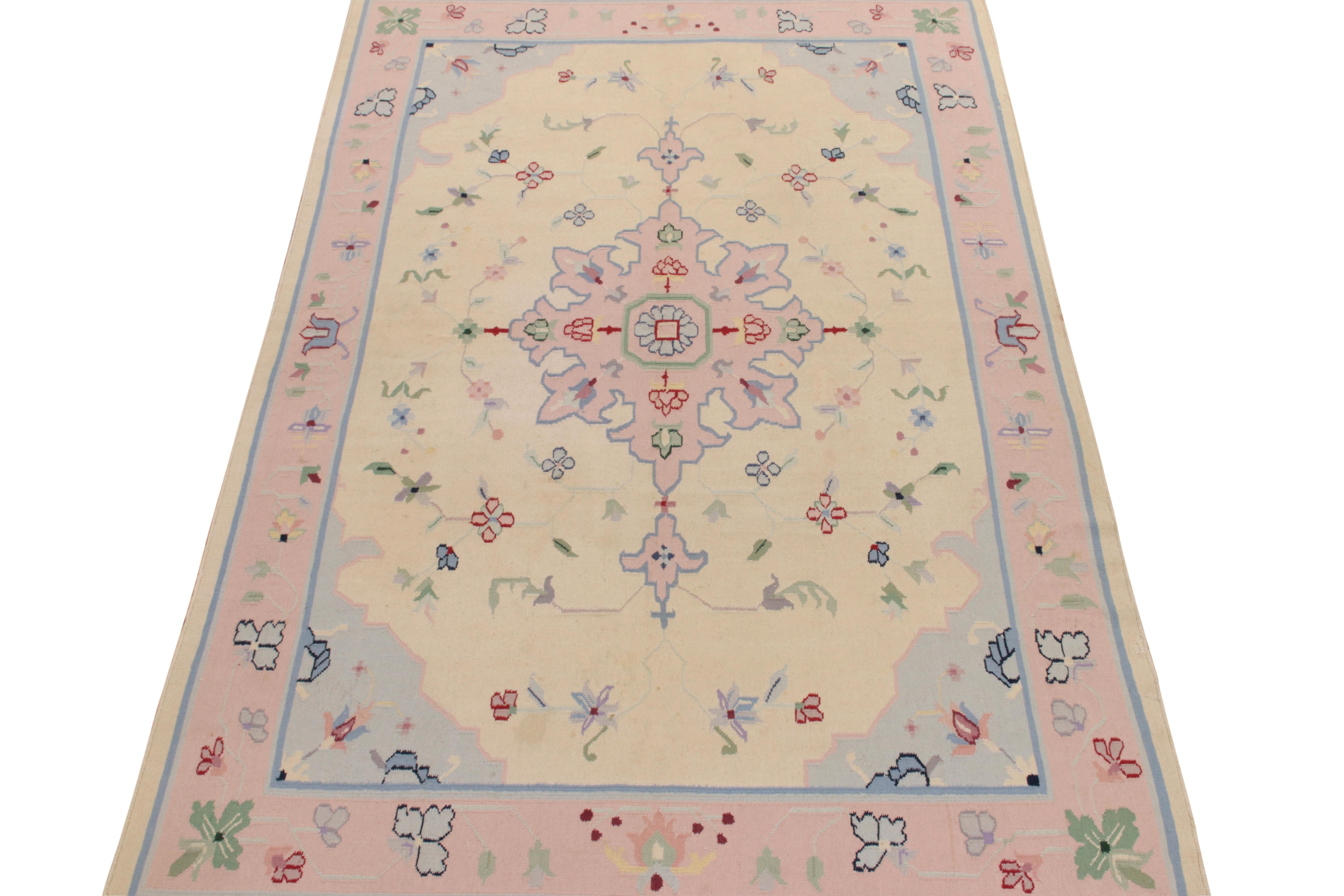 Handwoven in wool, a square 5x9 flatweave designed by one of the most modern designers in India—partner to Rug & Kilim. Acknowledged as a Dhurrie flatweave, this style features a sublime medallion in whimsical pink & pastel blue on a beige backdrop,