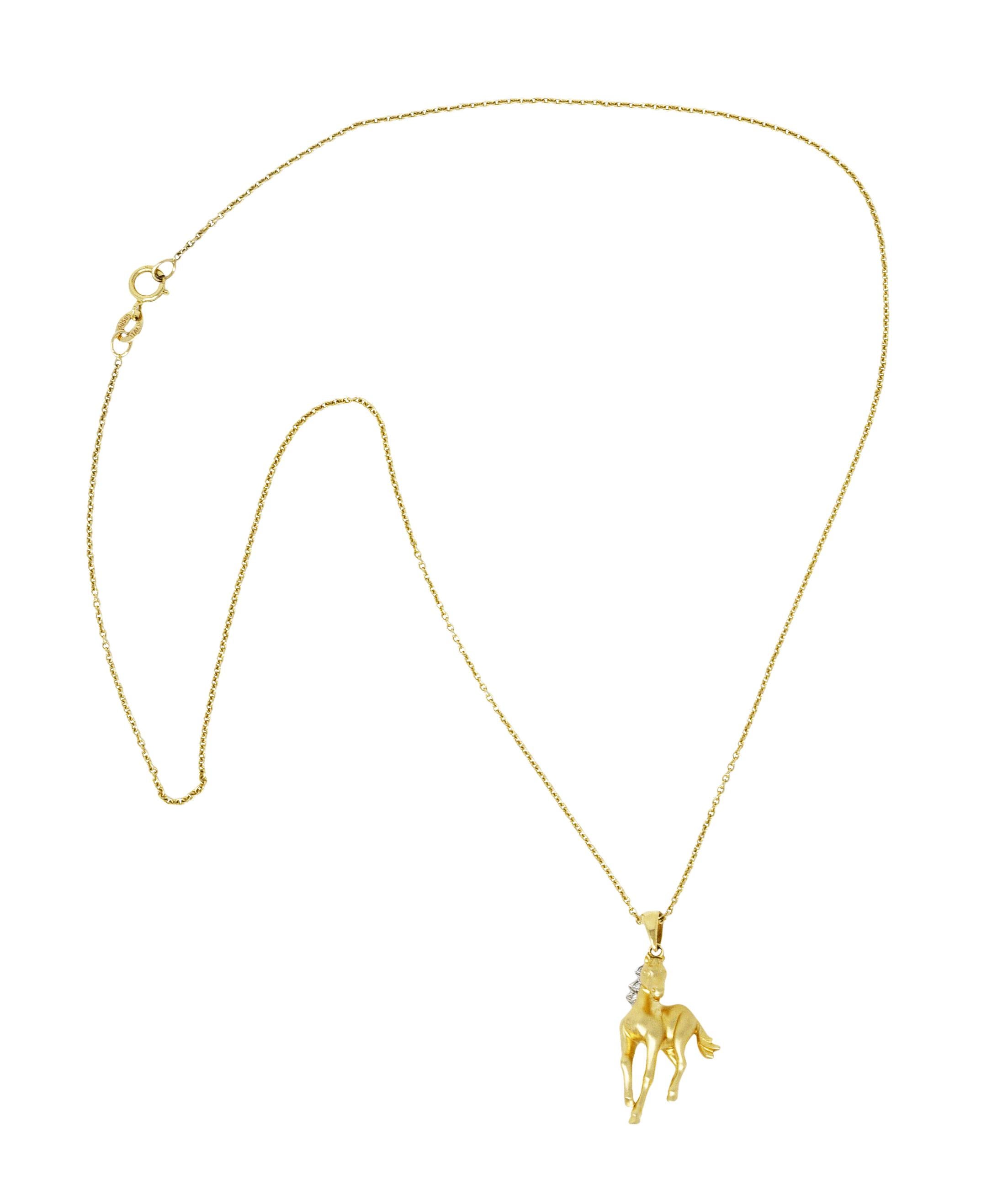 Necklace is designed as cable chain suspending stylized horse pendant

With sleek features and matte gold finish

Mane is accented by round brilliant cut diamonds bead set in white gold

Weighing approximately 0.03 carat total - eye clean and