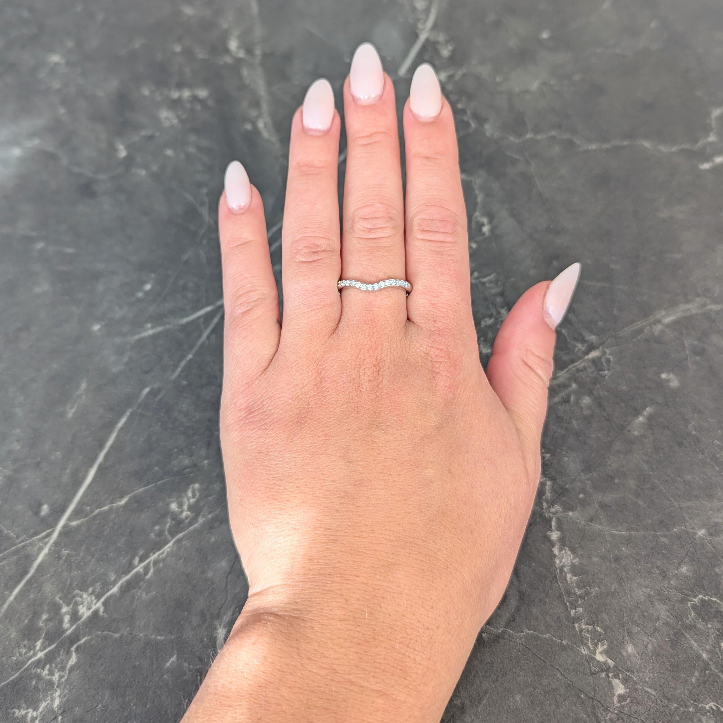 Designed as a contour style band with central curve
With round brilliant cut diamonds prong set to front
Weighing approximately 0.15 carat total
G/H color with VS2 clarity
Completed by high polish finish
Stamped for 14 karat gold
With maker's