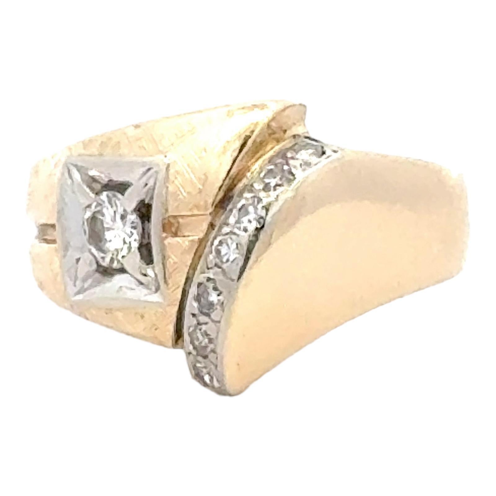 Contemporary diamond band ring fashioned in 14 karat yellow gold. The ring features an approximately .20 carat center diamond and another .15CTW of side diamonds. The diamonds are graded G-H color and SI clarity. The band graduates from 5-15mm in
