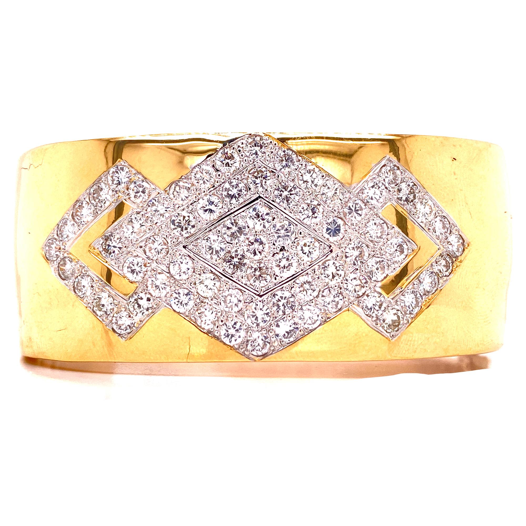 This stunning wide bangle bracelet is fashioned in solid 14 karat yellow gold. The square shape bangle features 75 round brilliant cut diamonds weighing approximately 4.50 carat total weight. The bangle measures 1.0 inch in width and 7 inches in