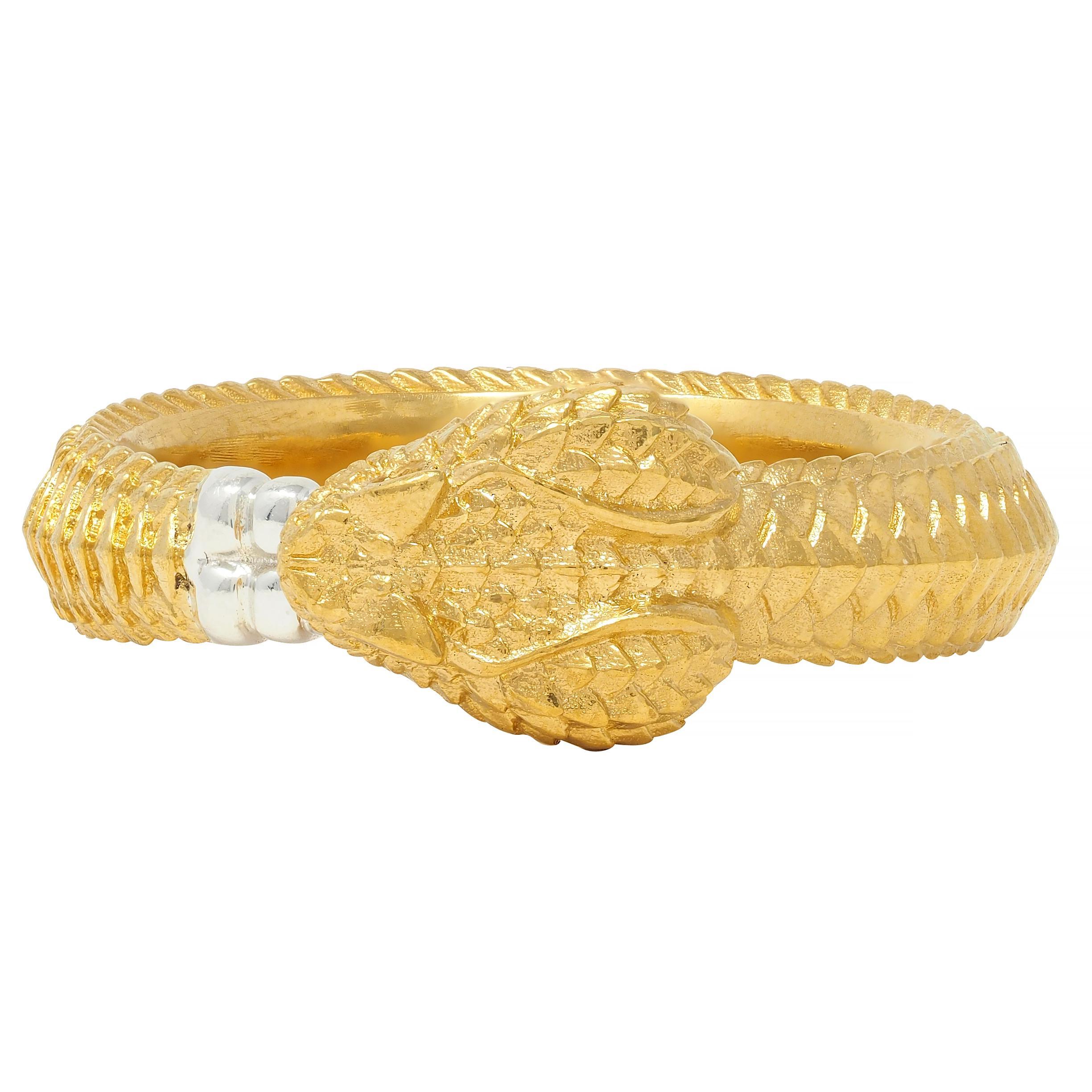 Designed as a highly rendered rattlesnake with grooved scales
Depicting an ouroboros motif with tail in mouth 
Accented by round brilliant cut diamond eyes - eye clean and bright
Rattle tip of tail is sterling silver
Stamped for 24 karat gold and