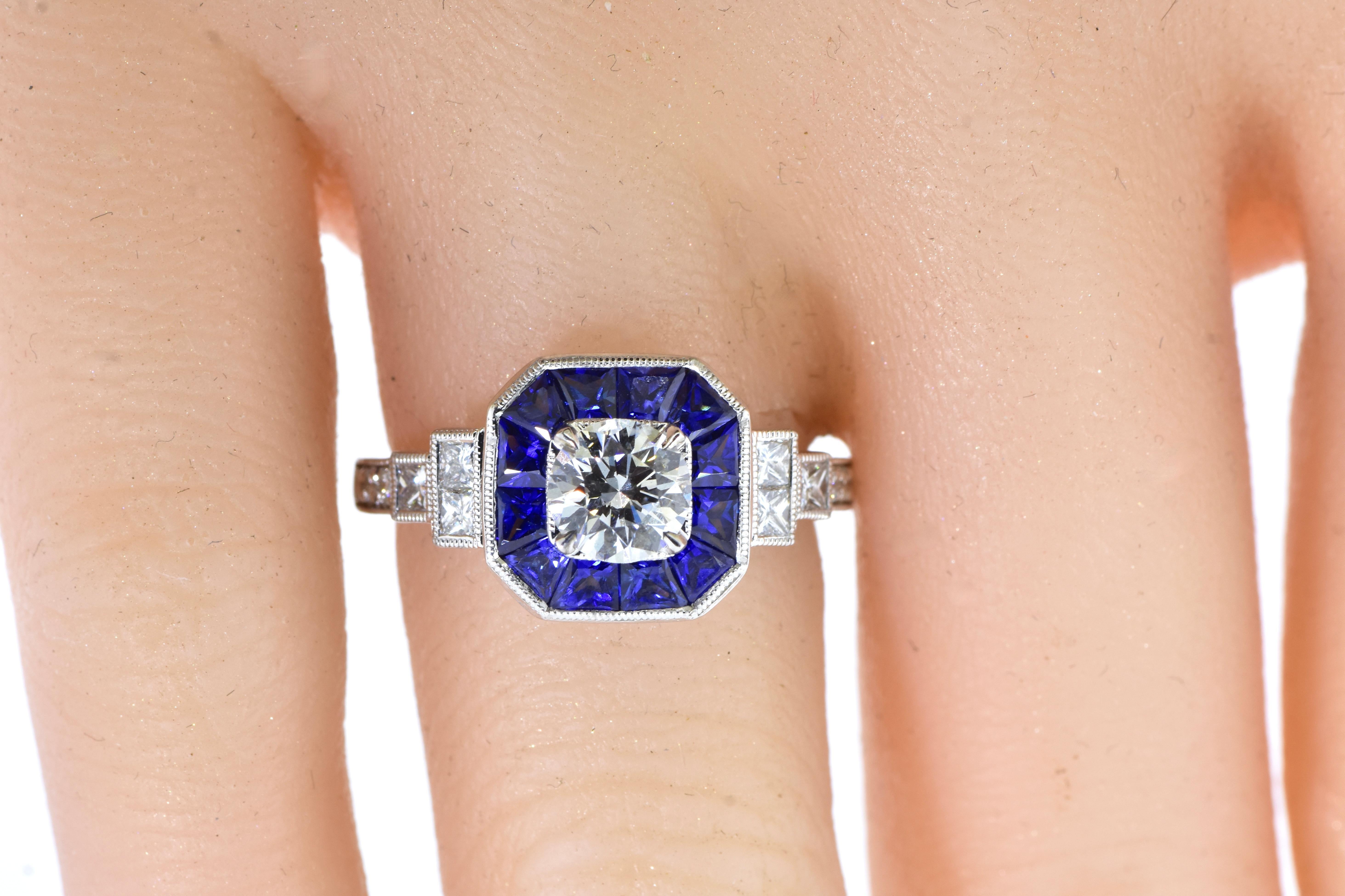 Sapphire and Diamond white gold contemporary new ring. 18K (marked 750), white gold well made ring possessing 12 fancy cut natural excellent color bright blue sapphires - not too light nor too dark - weighing an estimated 1.0 cts. the 12 smaller