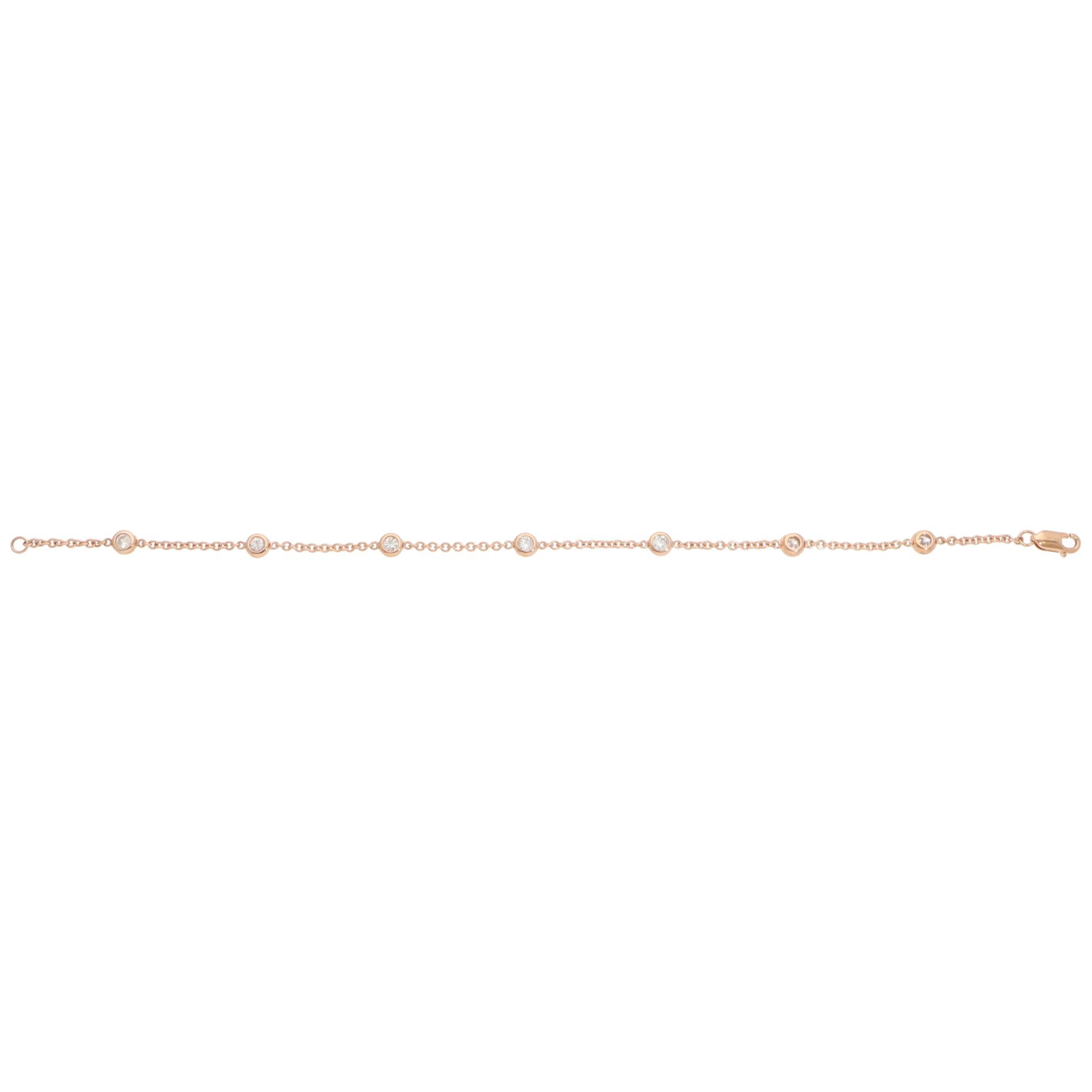 A beautiful contemporary diamond chain bracelet set in 14k rose gold.

The bracelet is composed of 7 round brilliant-cut diamonds connected by rose gold trace chains, secured with a lobster claw fastening. Each diamond is encased in a white gold