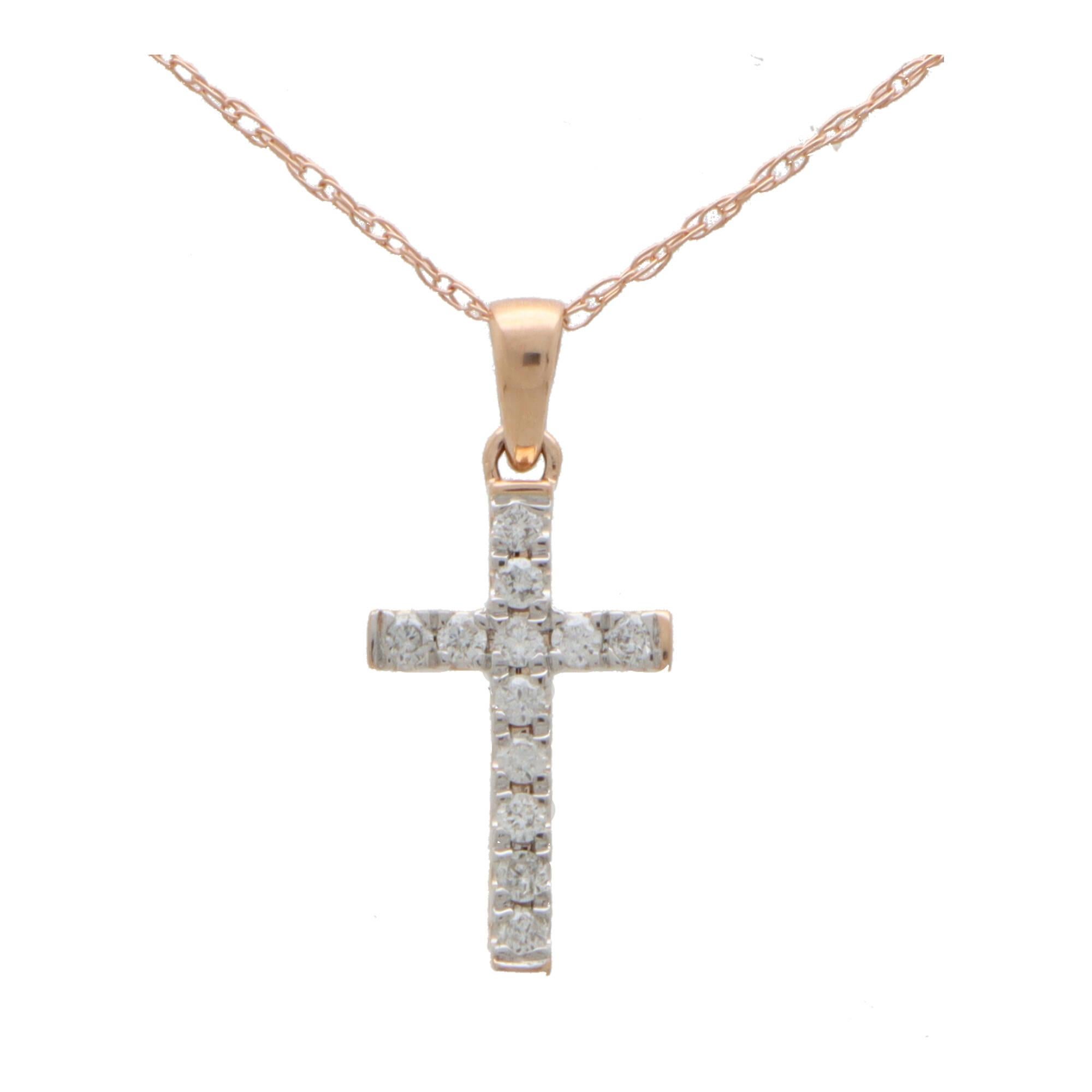 A dainty diamond cross pendant necklace set in 14k rose and white gold.

The pendant depicts a cross motif and is claw set with exactly 12 round brilliant cut diamonds. The cross hangs from a rose gold bail and hangs from a fine 18-inch rose gold
