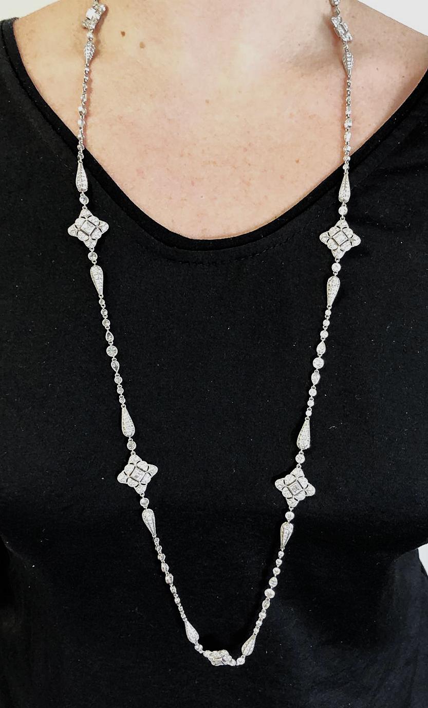 Contemporary Diamond Deco-Style Opera Necklace in Platinum.
An elegant fine jewelry long necklace exquisitely crafted in an Art Deco-style. Eight double-sided graphic florets featuring square caret-cut diamonds are surrounded with round brilliant