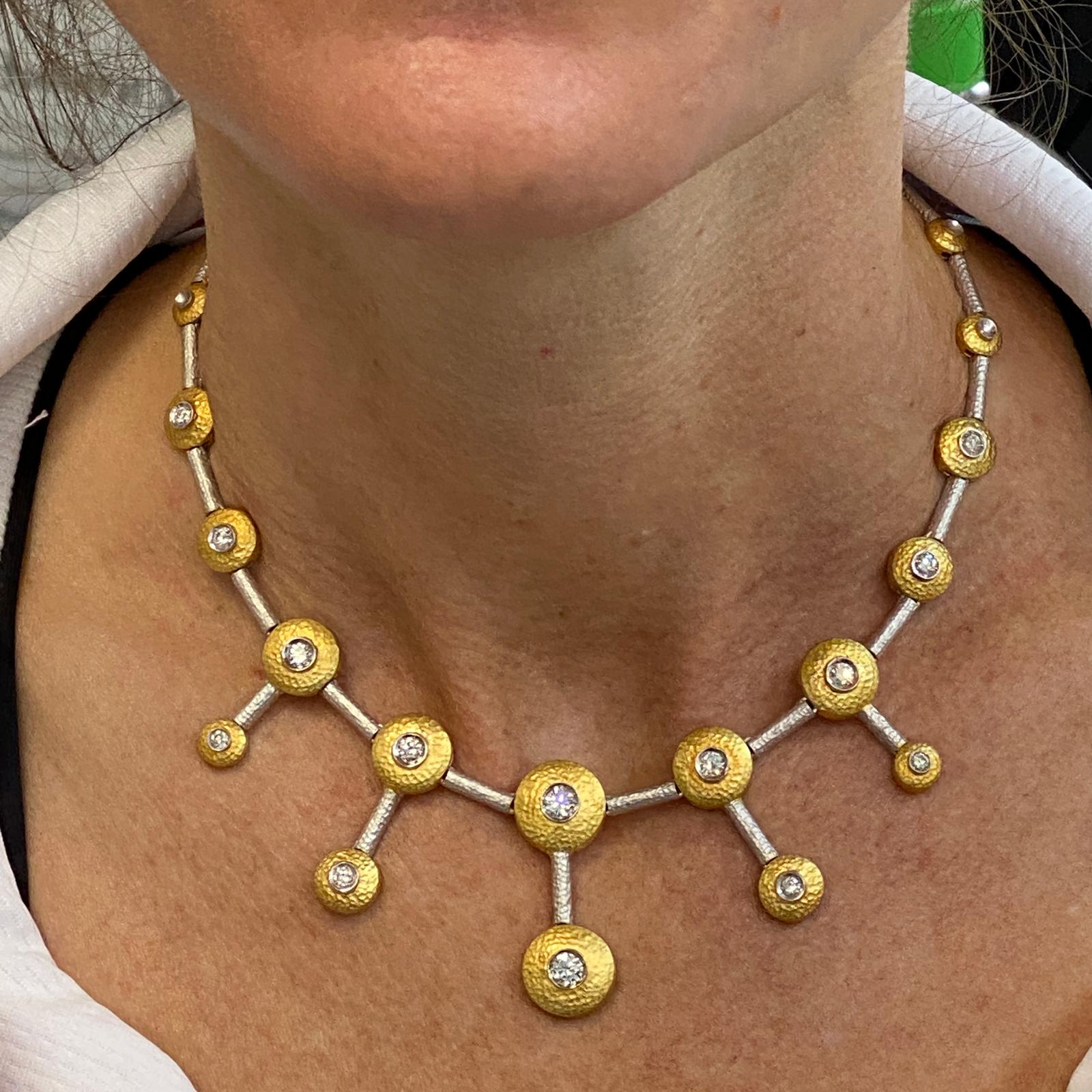 Fabulous diamond drop necklace fashioned in hammered 18 karat yellow and white gold. The necklace features 14 round brilliant cut diamonds weighing approximately 2.25 carat total weight and graded G-H color and VS clarity. The necklace measures 14