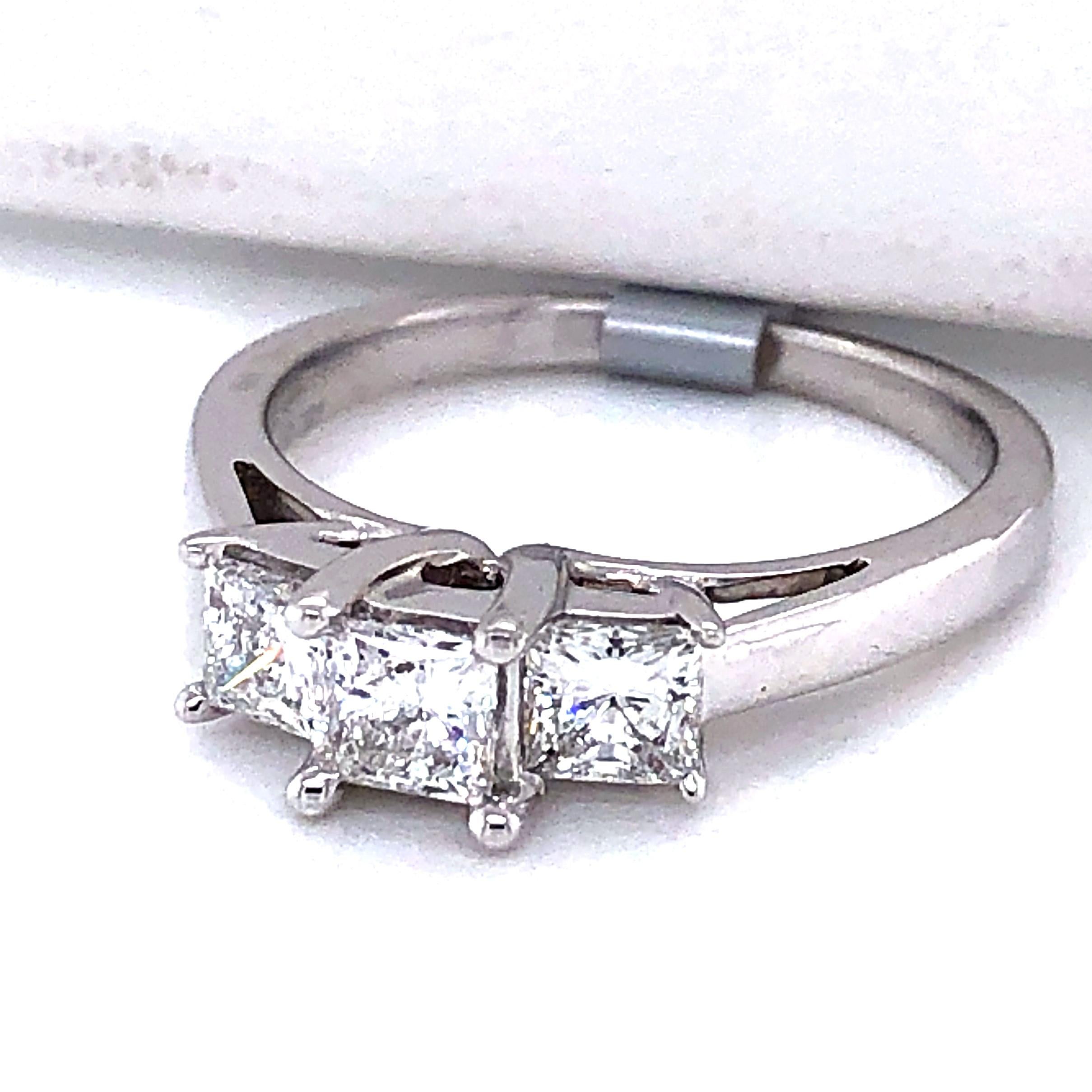 18 karat white gold (stamped 18K KRN CELEBRATION) set with a 3.9mm princess cut diamond in the center, approximately 0.38 carat wth H/I color and S11/SI2 clarity and two 3.7mm side princess cut diamonds, approximately 0.30 carat each with matching