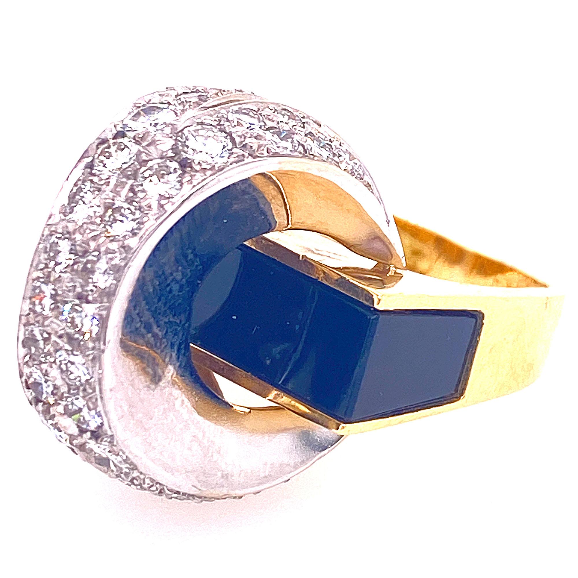 Fabulous contemporary ring featuring white sparkling diamonds and black onyx gemstone. The ring is crafted with 2.00 carats round brilliant cut diamonds set in 14 karat yellow and white gold.  This 1960-1970's ring measures 20mm in height, 20mm in