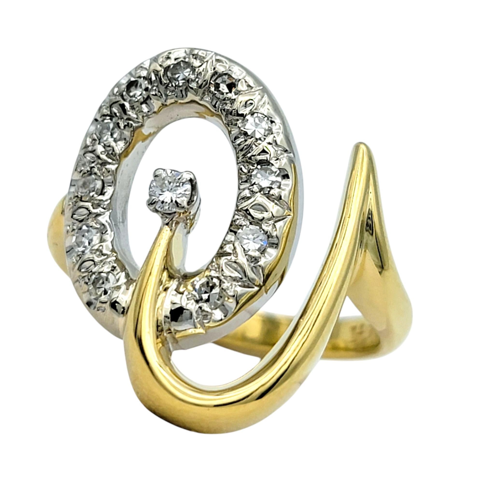 Ring Size: 7

A stunning display of modern elegance, this diamond ring is a unique and sophisticated statement piece. Designed in a captivating open loop motif, it features a graceful blend of 18 karat white and yellow gold, creating a striking