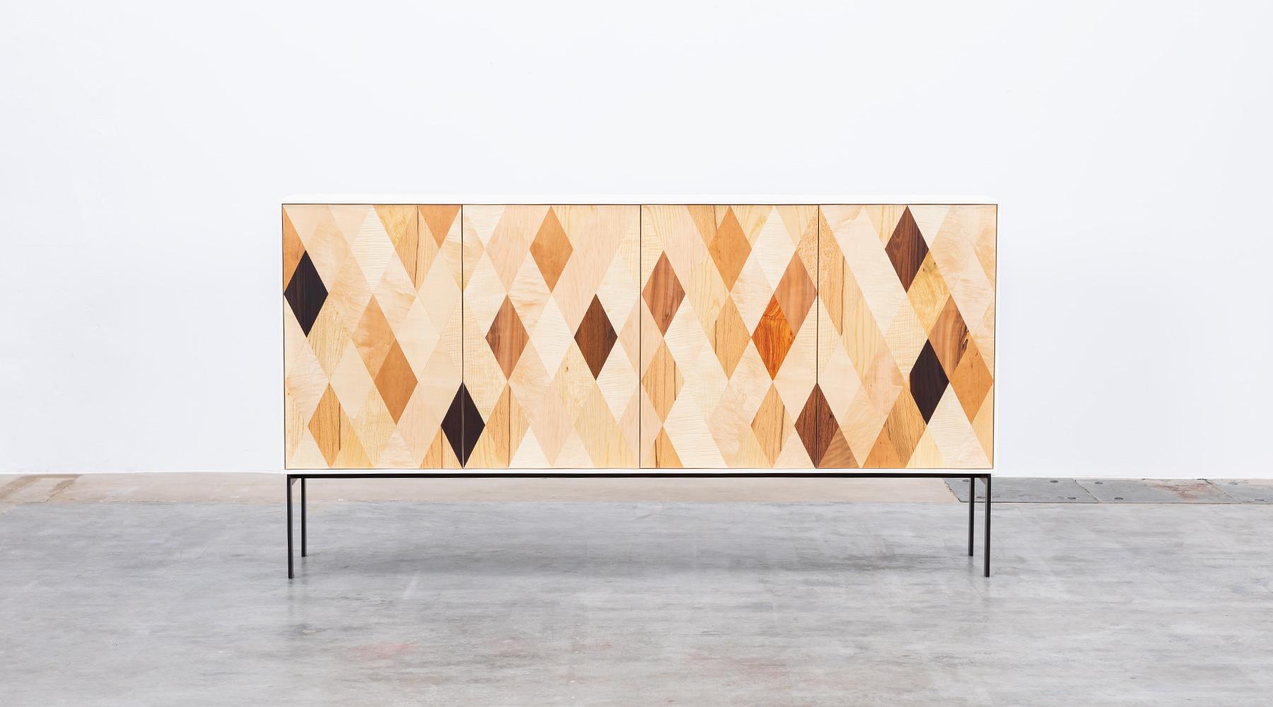 The body of this sideboard is made of solid HPL in white, the interior and inside of satin nut, the doors of this unique piece of diamond shaped veneers of various origin such as maple, bleached maple, birds eye maple, oak, bleached oak, alder,