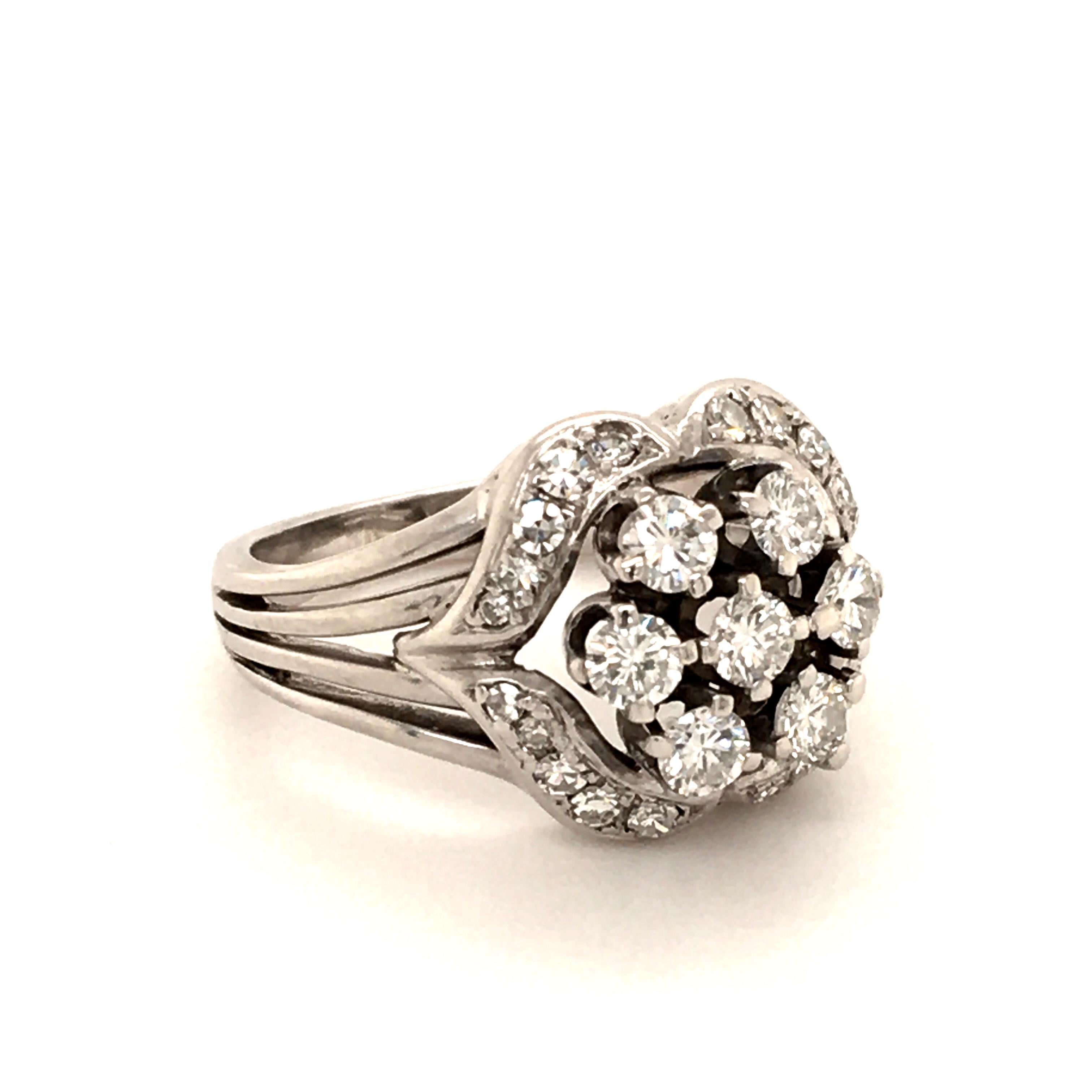 Playful ring in 18 Karat white gold. Designed as a cluster of seven brilliant-cut diamonds of G/H-vs quality totalling approximate 0.70 ct; embedded in 20 single-cut diamonds totalling 0.30 ct.
Classy look from the 1960ies.

Size: 54 EU / 6.5