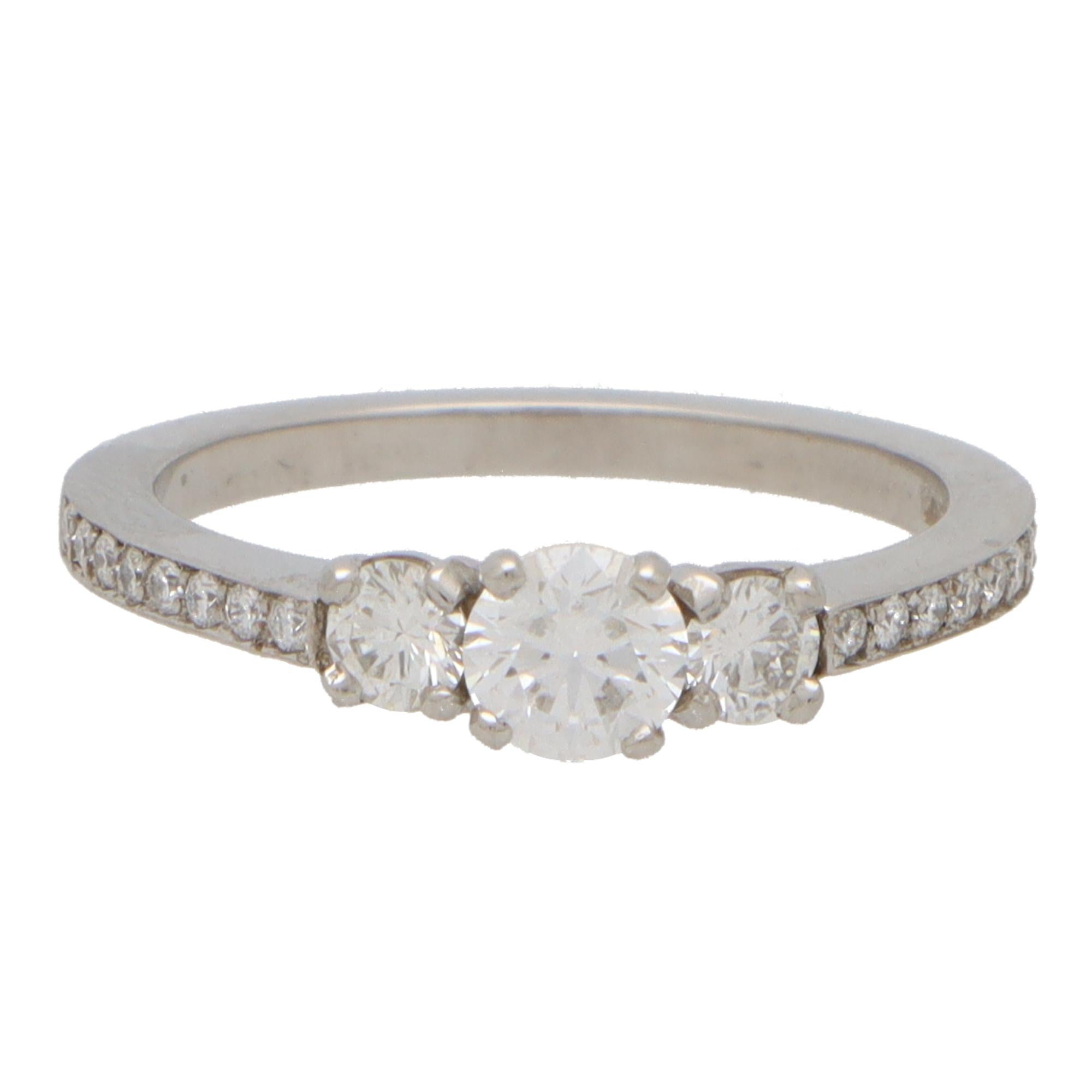 Round Cut Contemporary Diamond Three Stone Ring With Diamond Shoulders in Platinum