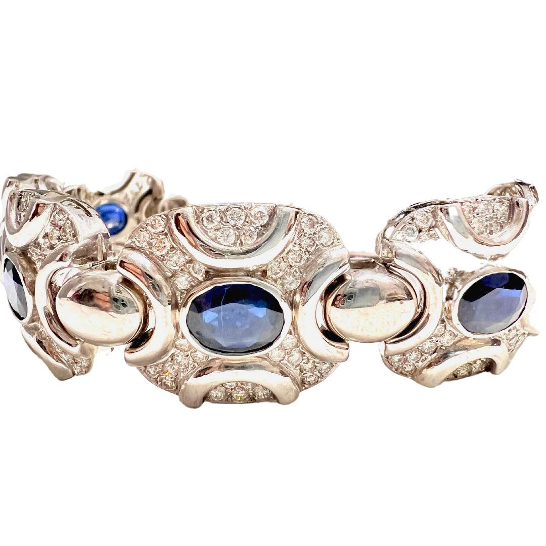 This contemporary 20th-century link bracelet is an exquisite piece crafted from 18k white gold, adorned with diamonds and sapphires. With a total of 5.40 carats, the brilliant-cut diamonds shimmer elegantly alongside the oval-cut sapphires, creating