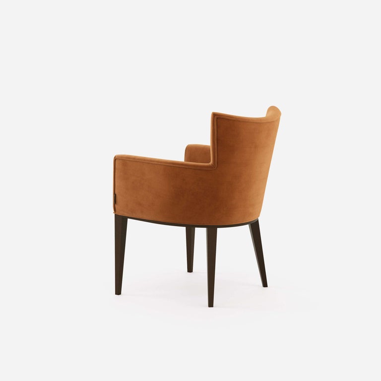 Timeless design in combination with handmade couture techniques. The dining chair features curved wooden upholstered back for greater comfort. Offered in fumed Oak frame and brick velvet that is resistant to stains and abrasion.
Brass caps are