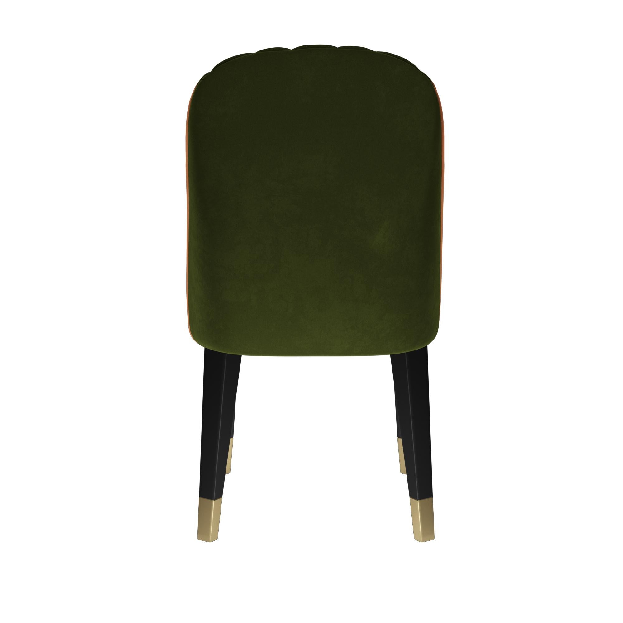 Contemporary dining chair featuring a sculptural curved back with tufted padding to achieve the perfect angle for relaxation. Upholstered in green velvet with very soft alpaca wool look and feel. The velvet is stain resistant and water