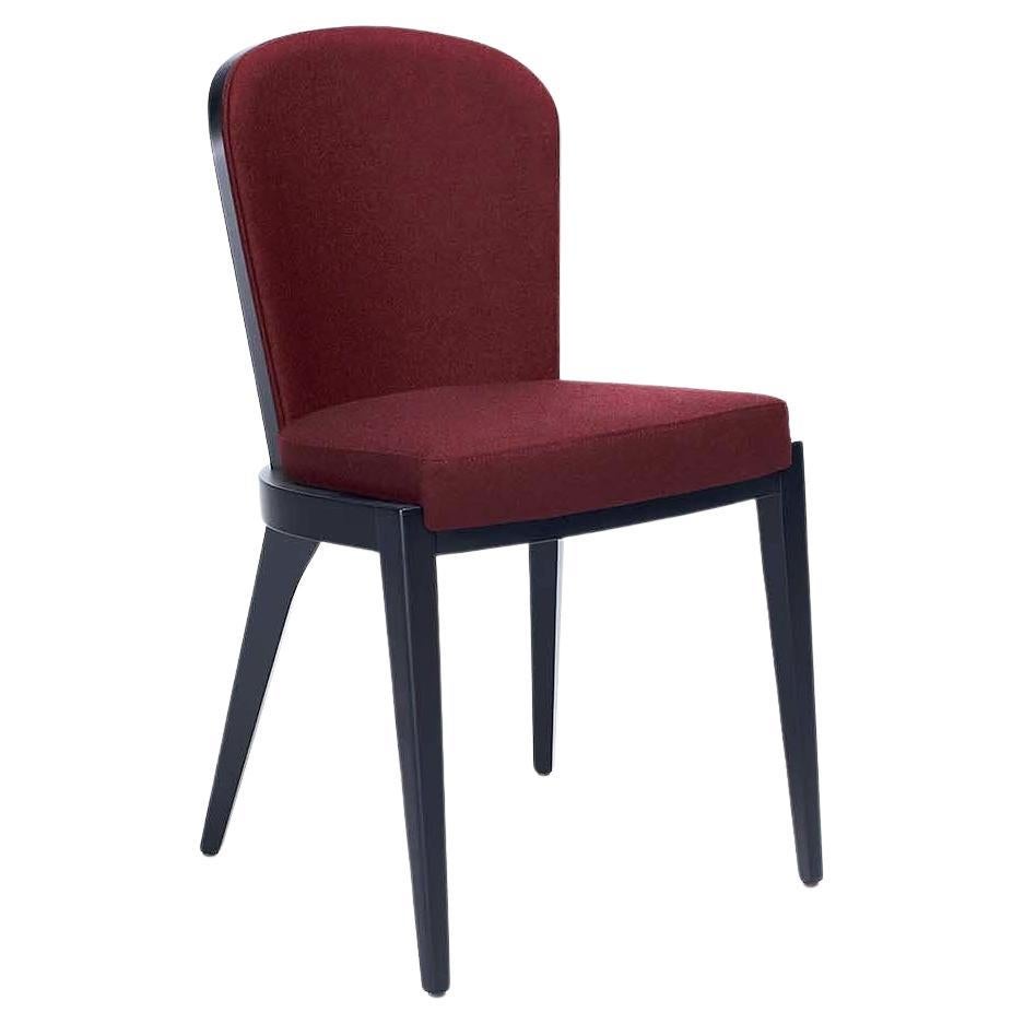 Timeless design in combination with handmade couture techniques. The dining chair features curved wooden upholstered back for greater support. Offered in wengè finsihed frame and woven wine fabric that is resistant to stains and abrasion 
Fabric