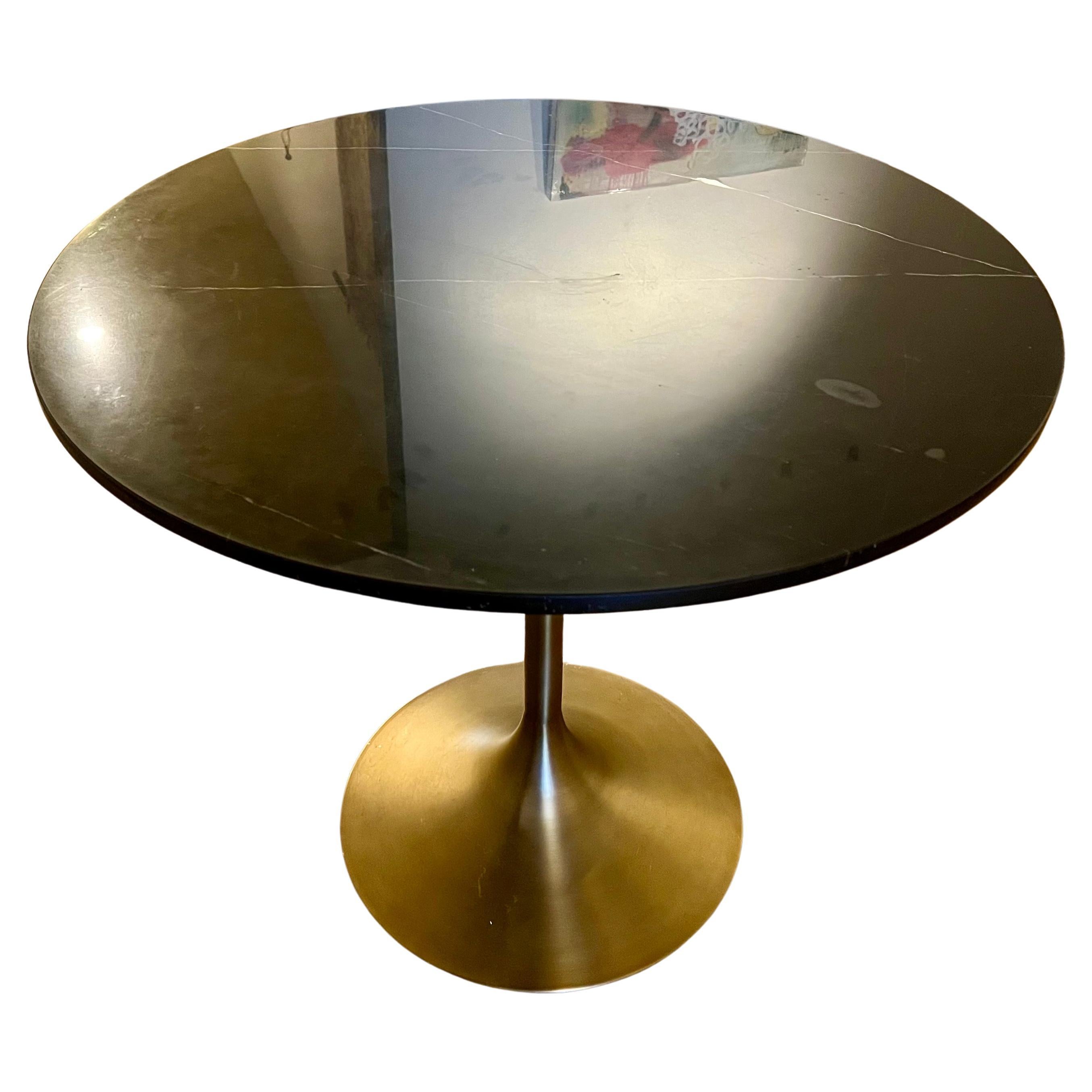 A very good looking black marble top with a Saarinen style base in bronze finish , and metal the top comes off for easy shipping with beautiful grain some light spots due to age as shown , co chips or cracks, very clean overall with light marks