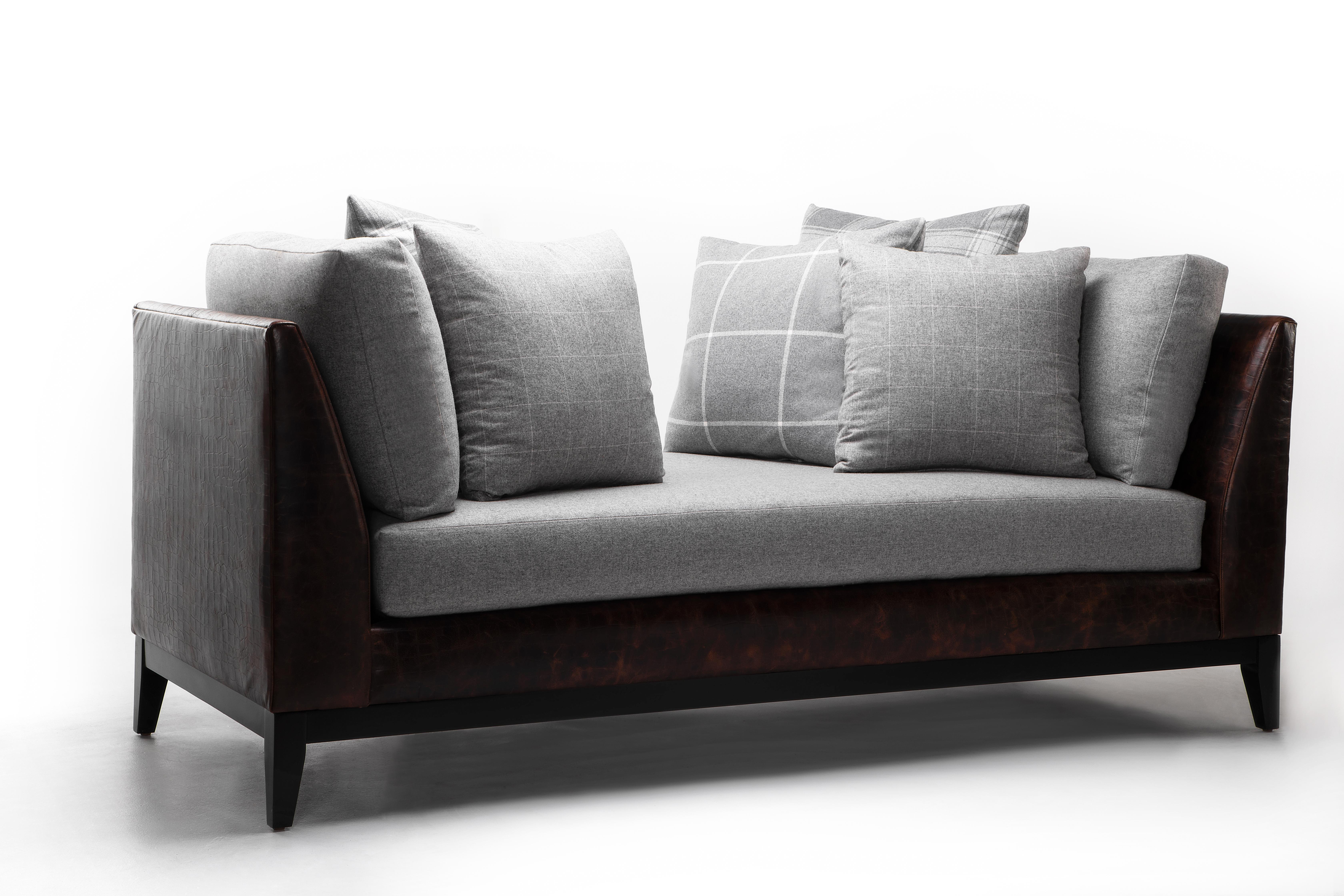Domenico daybed is handsome yet functional. Anchored by a chocolate leather-covered base, this modern daybed emotes a sleek and cozy feeling with its grey Cavalier wool cushions and coordinating Ralph Lauren plaid pillows. Additional fabrics