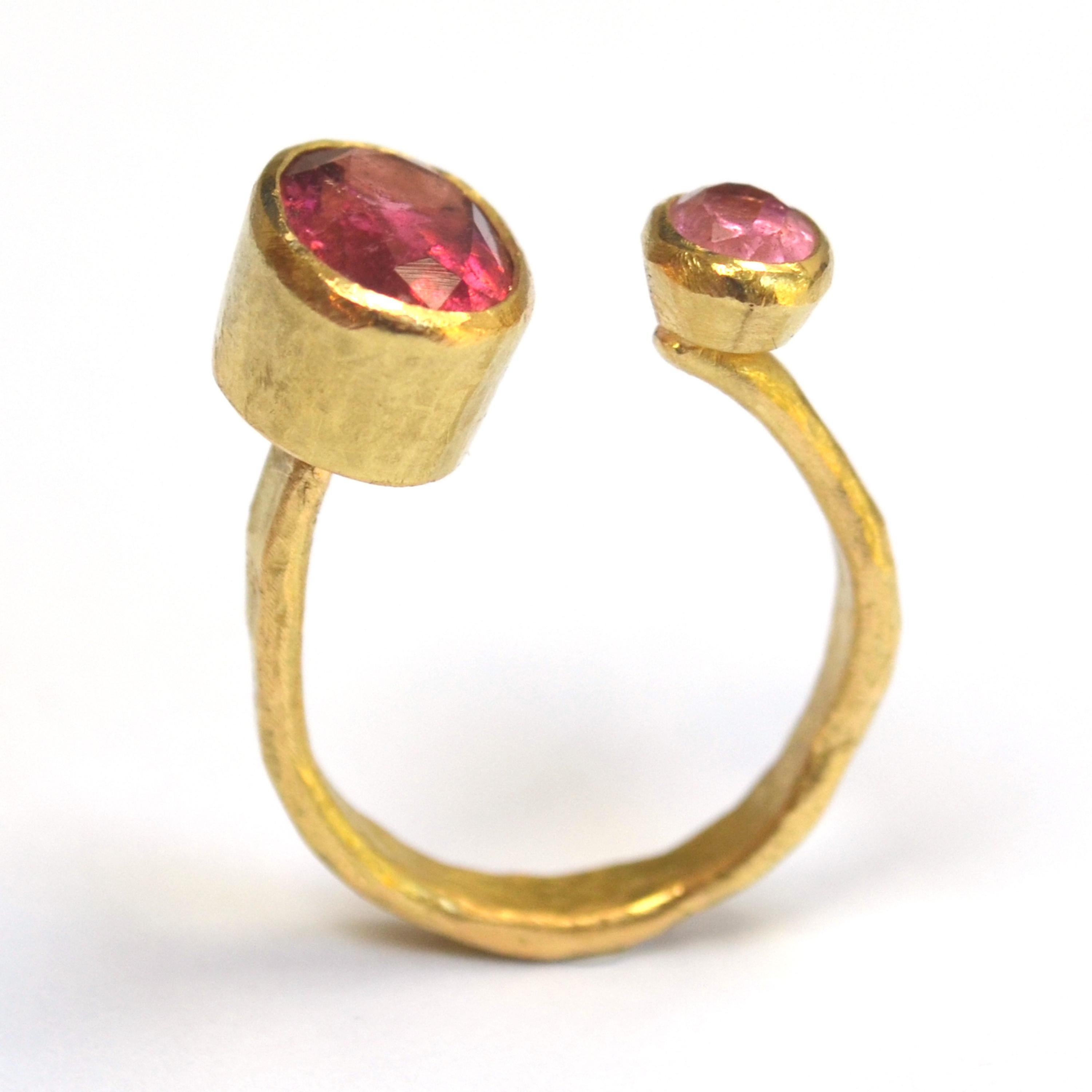 18k Gold textured open ring with two oval Pink Tourmalines, approximately 3 carats and 0.75 carats each.

This ring has been handmade by Disa Allsopp in her London Studio. Disa is inspired by ancient jewellery and uses traditional Goldsmithing