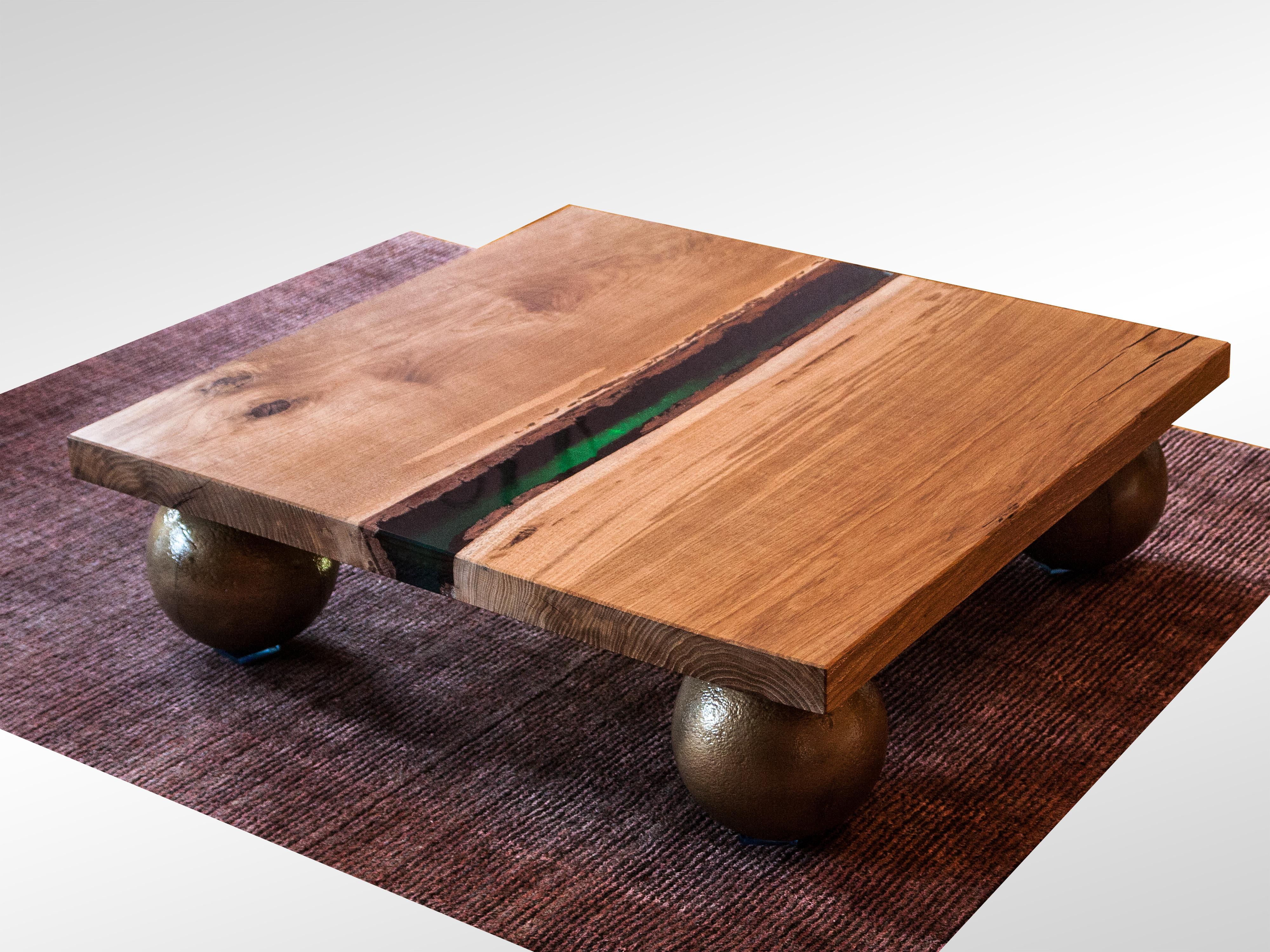 This unique Durmast coffee table was soaked in epoxy resin and is crossed by an emerald epoxy resin band in its center. The light going through it makes it look really amazing. The tabletop is 5 cm thick.
The table base is made of 4 real bowling