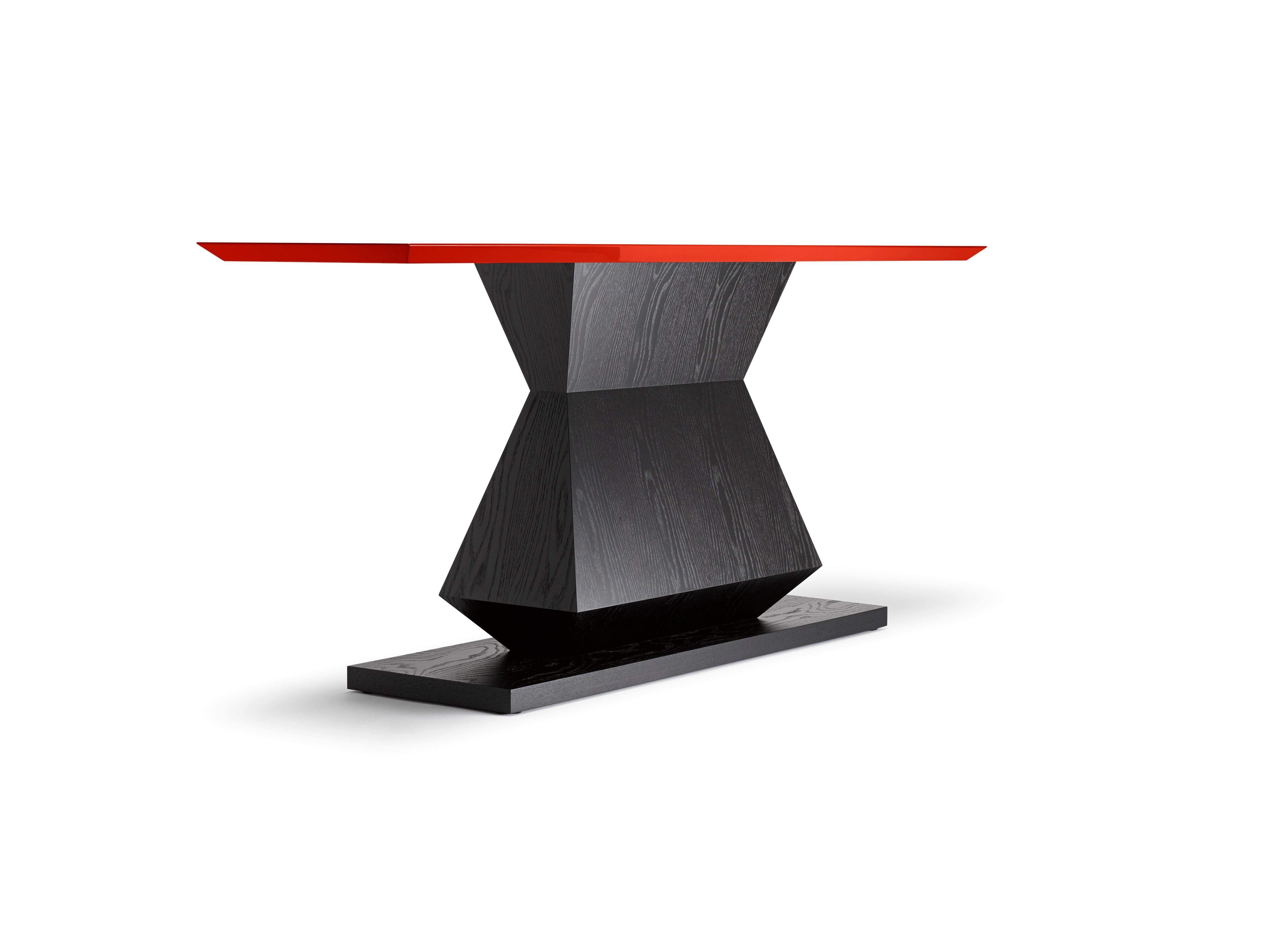 With its angular, symmetrical base and bevelled top this Edo Console table is also available as a console, occasional or dining table, with any RAL referenced lacquer colour to the top. Shown here in ebonised oak with a red lacquered top. (also