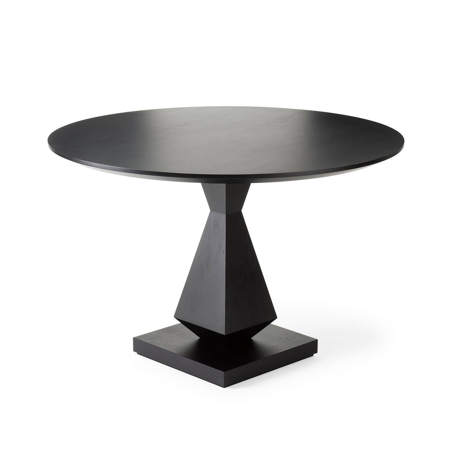With its angular, symmetrical base and bevelled top this design is available as a console, occasional or dining table, with the option of specifying a lacquer color to the top. Shown here in black lacquered walnut.

Fourth image shows the lacquer