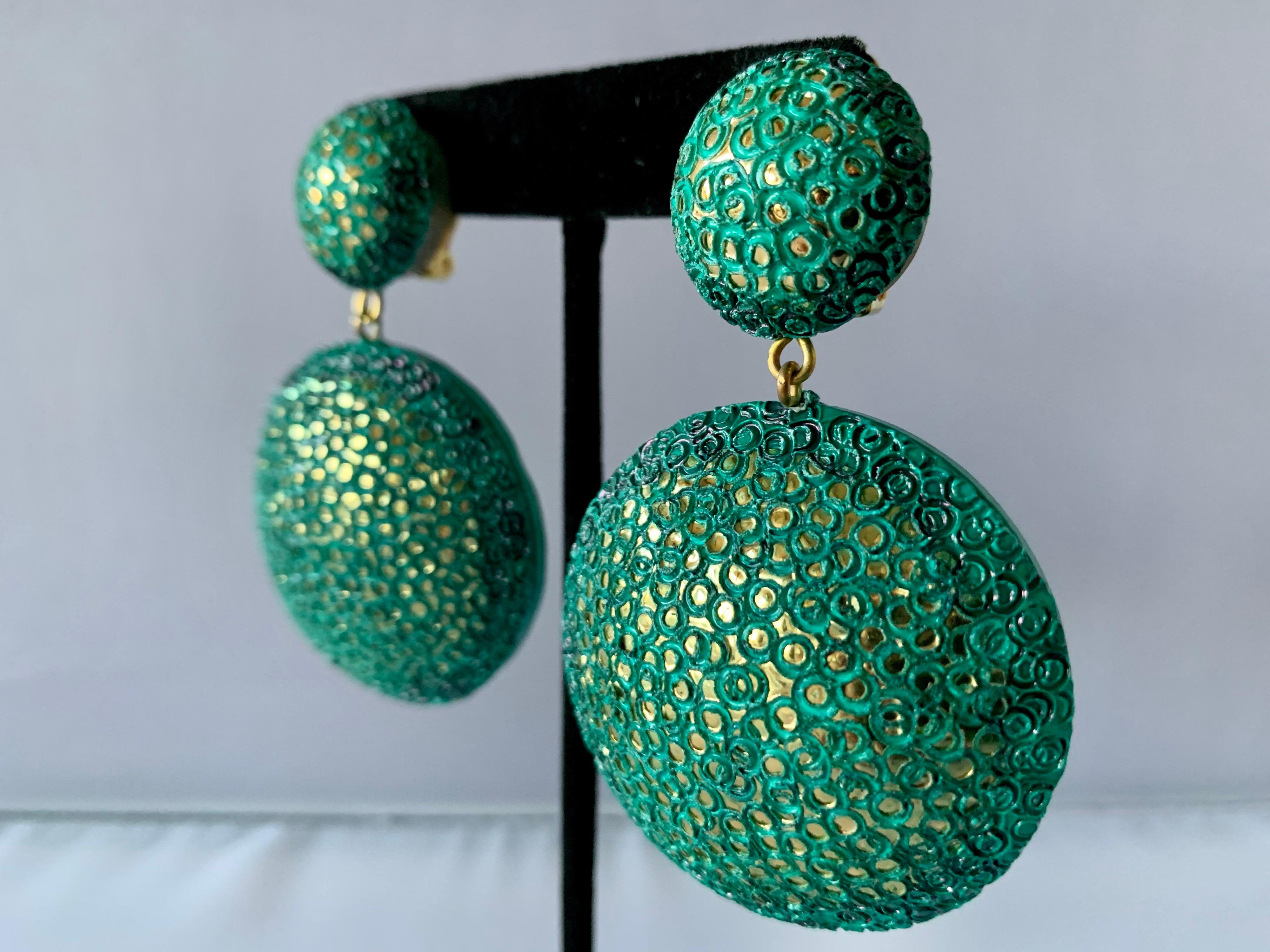 Light and easy to wear, these handmade artisanal clip-on earrings were made in Paris France. The lightweight clip-on earrings feature molded disk segments of enameline (enamel and resin composite) in electric turquoise color. The earrings are