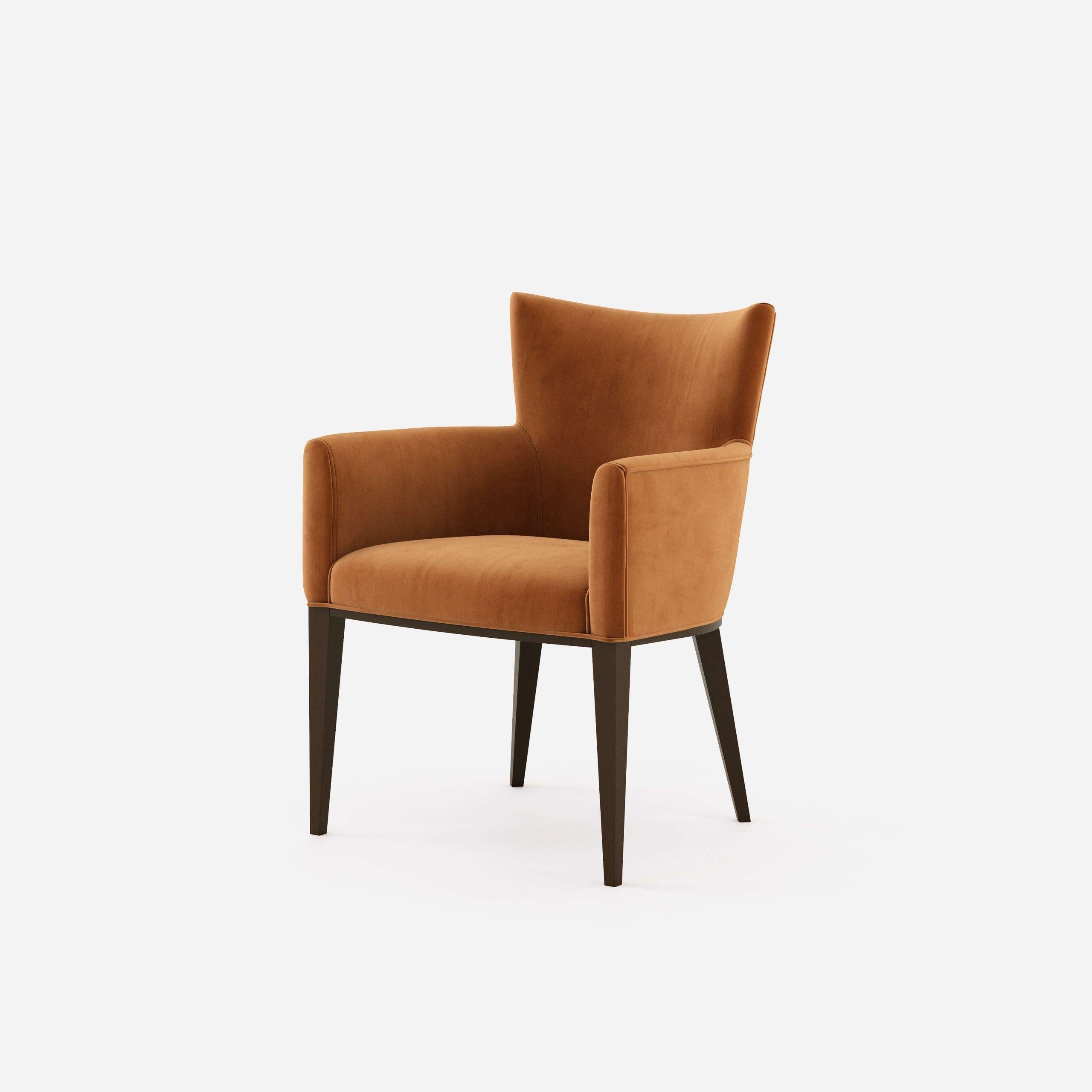 Timeless design in combination with handmade couture techniques. The dining chairs features curved wooden upholstered back for greater comfort. Offered in fumed Oak frame and brick velvet that is resistant to stains and abrasion.
Brass caps are