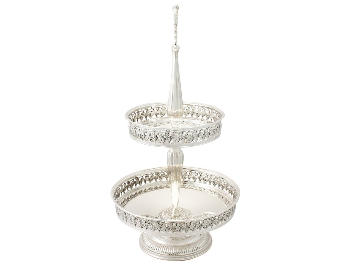 A fine and impressive contemporary Elizabeth II English sterling silver cake stand/centerpiece; an addition to our ornamental silverware collection.

This fine contemporary Elizabeth II sterling silver cake stand / centerpiece has a two-tiered