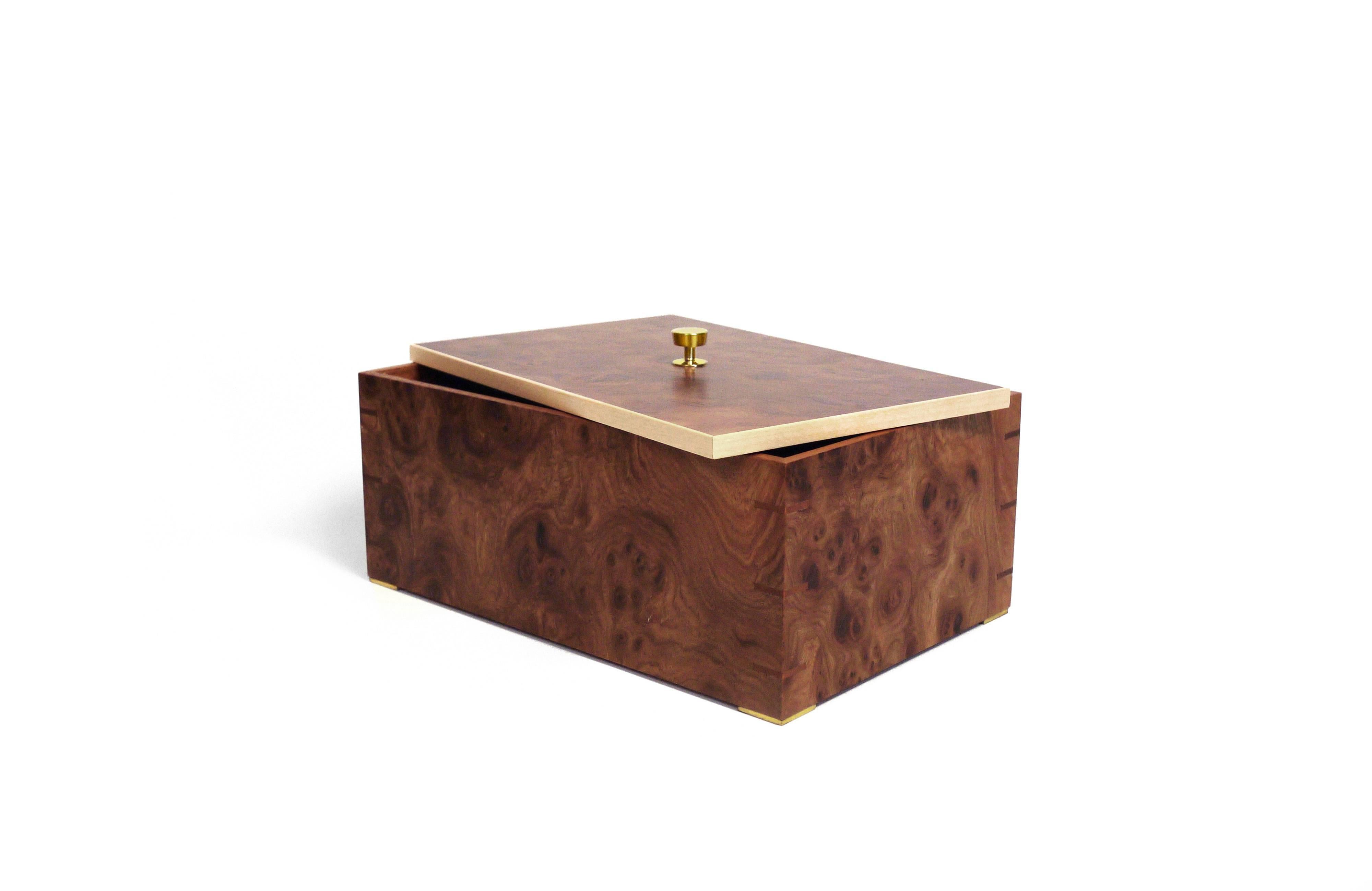 Part of Les Few's LaMiel collection, this contemporary, elmroot, mahogany and brass, modern, minimalist wood box with birch details, is made by artisans in Sweden. The box comes with the choice of a leather interior in granite grey, anthracite,