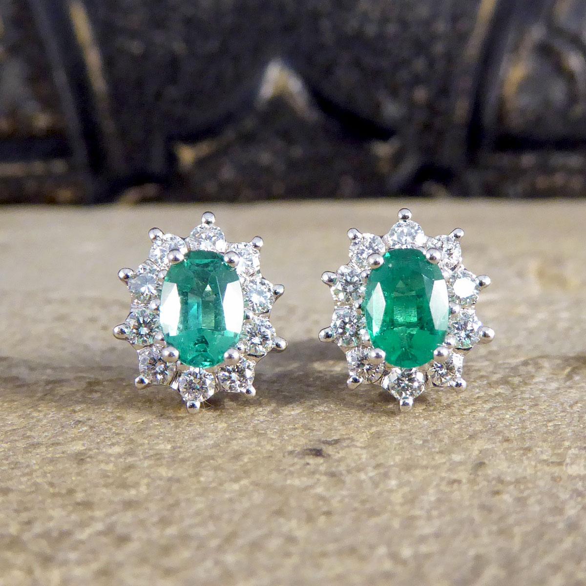 These beautiful stud earrings feature one oval cut Emeralds weighing 0.40ct each showing a lovely and mesmerising green colour. Each Emerald is surrounded by ten round cut Diamonds in claw settings, weighing 0.50ct in total of both ears. This pair
